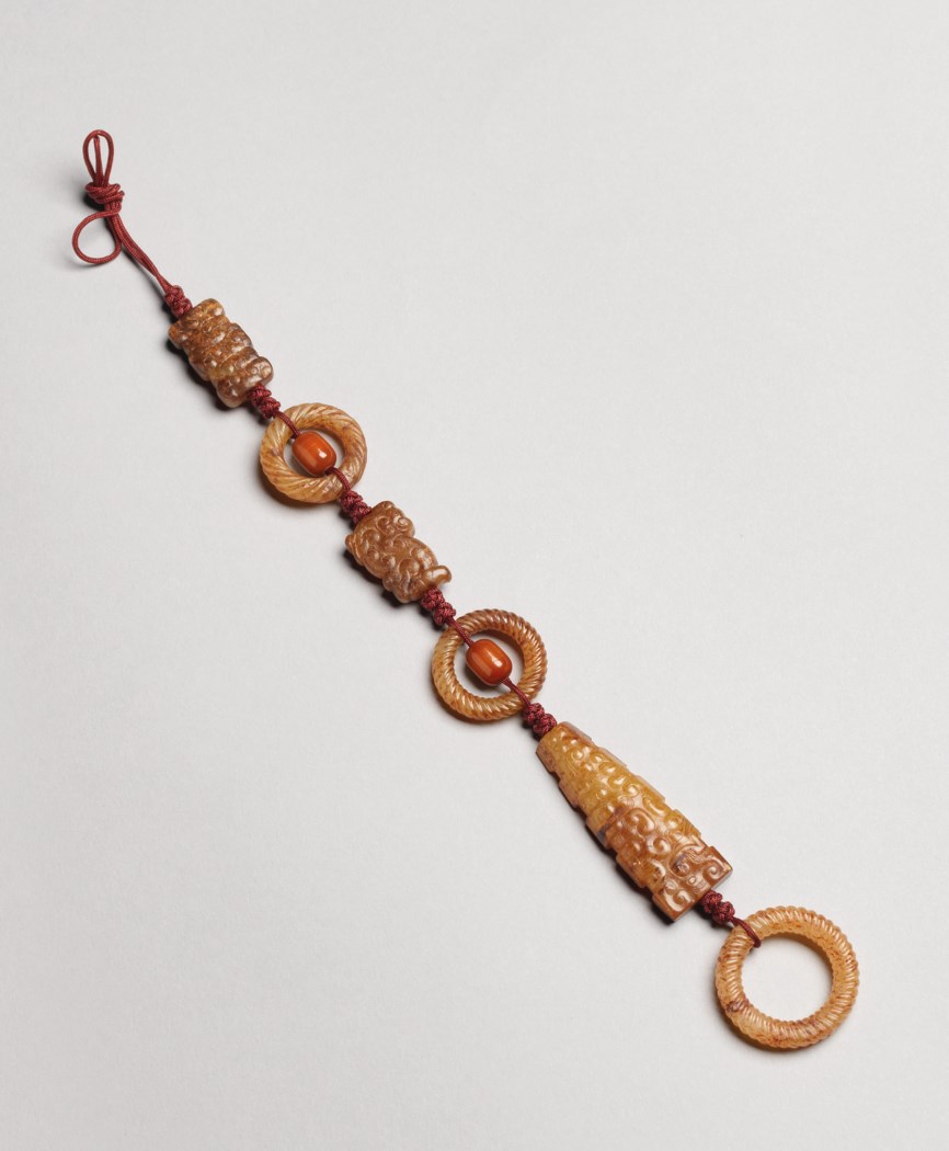 A SET OF RUSSET JADE ORNAMENTS, SPRING AND AUTUMN PERIOD (770476 BC