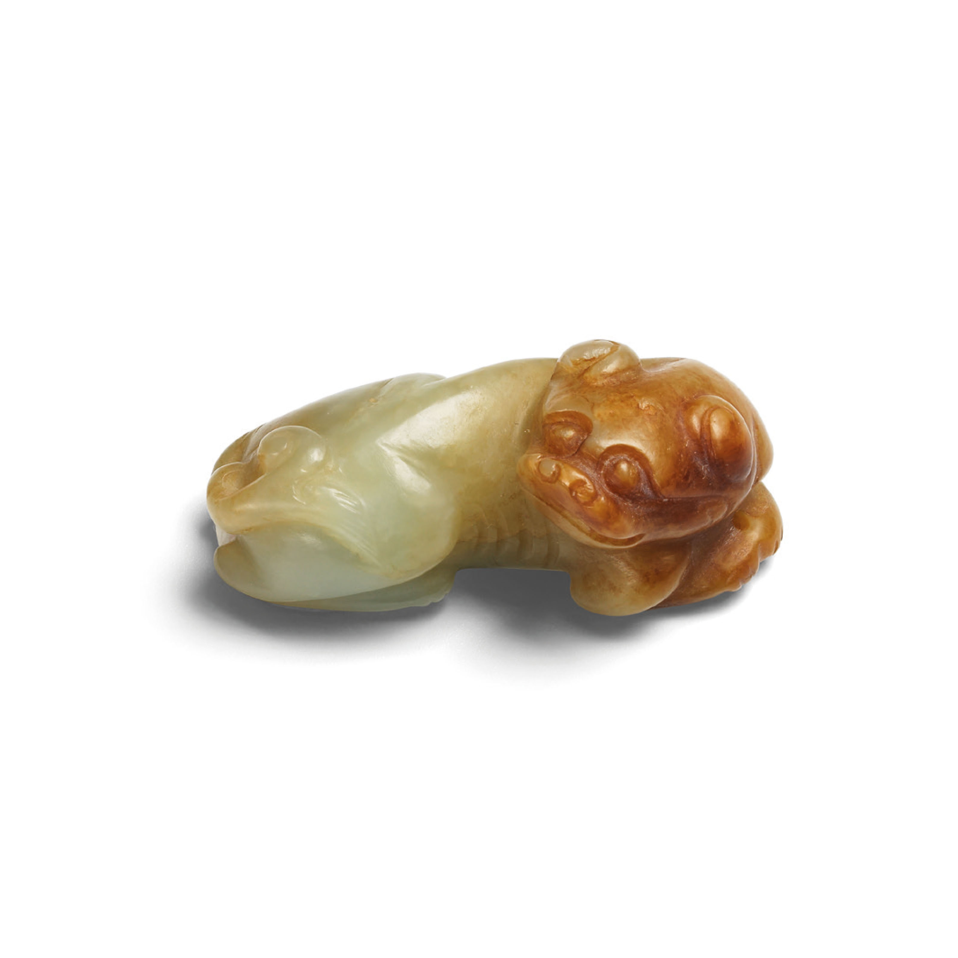 A CELADON AND RUSSET JADE CARVING OF A MYTHICAL BEAST , MING DYNASTY