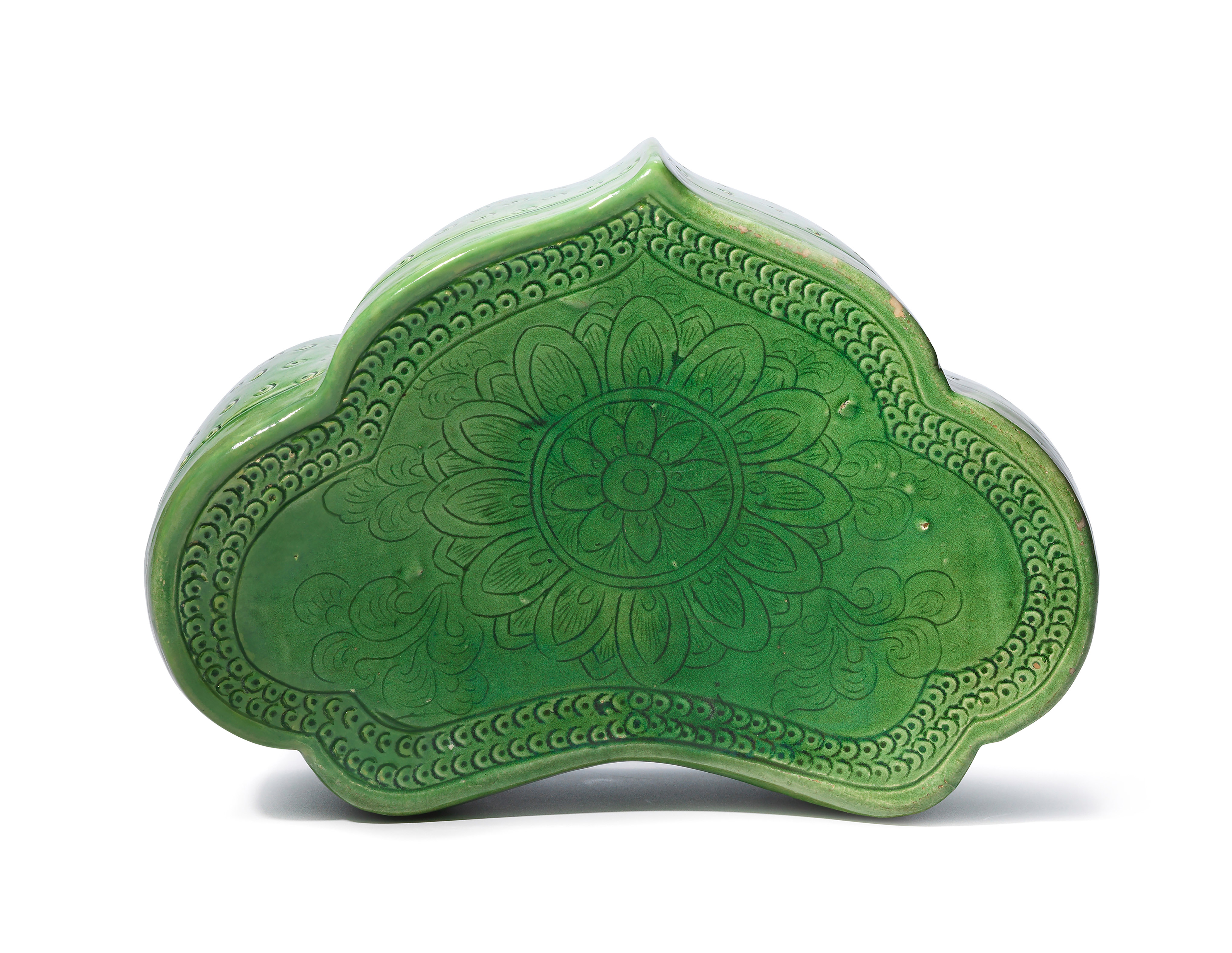 A rare Ding green-glazed carved &lsquo;Indian lotus&rsquo; ruyi-shaped pillow, Northern Song dynasty (960-1127). Price Realised: HK$81,250.00, 11 October 2017, Online