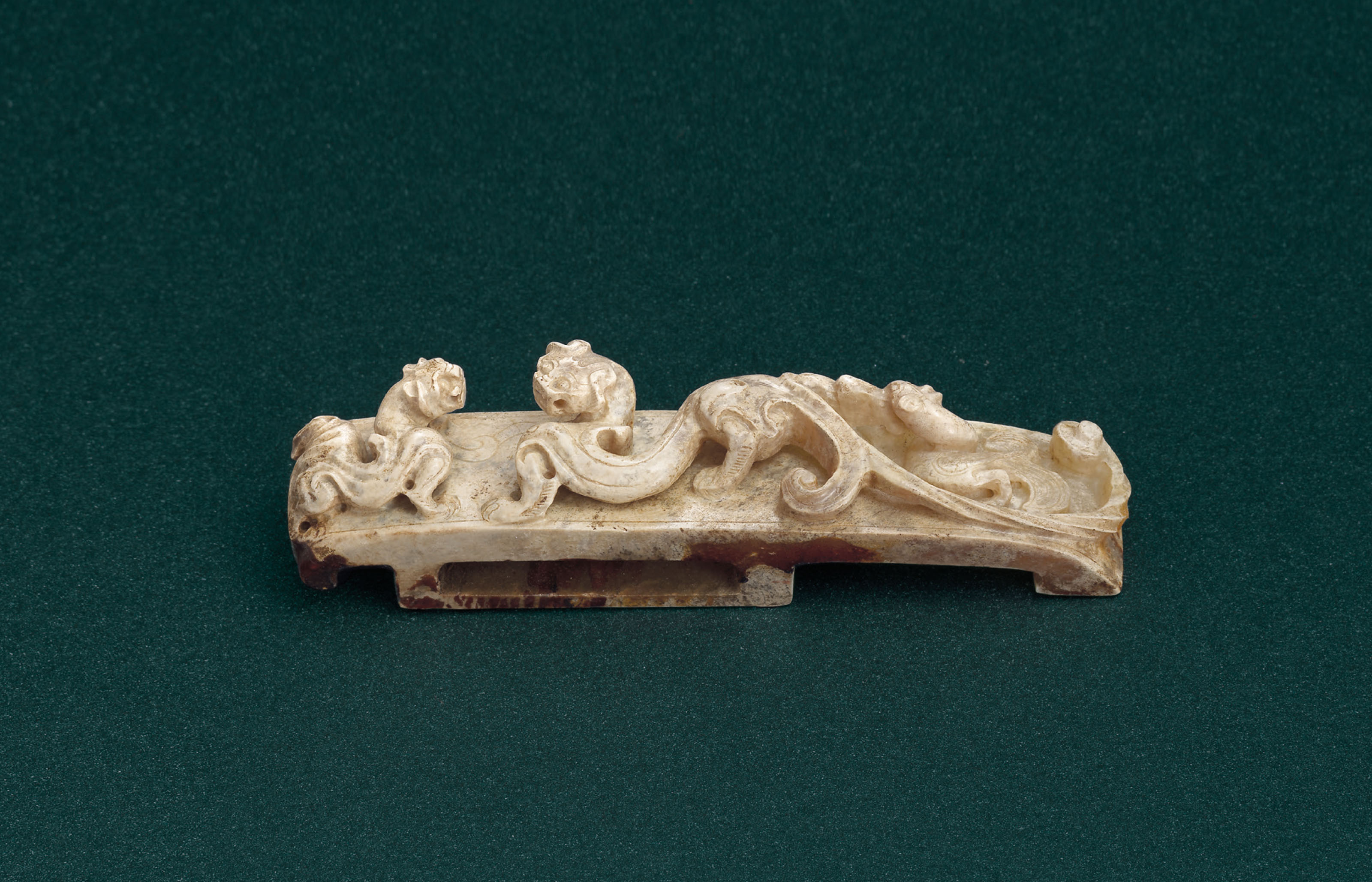 A FINELY CARVED JADE ‘THREE GUARDIANS’ SCABBARD SLIDE , WESTERN HAN DYNASTY (206 BCAD 8