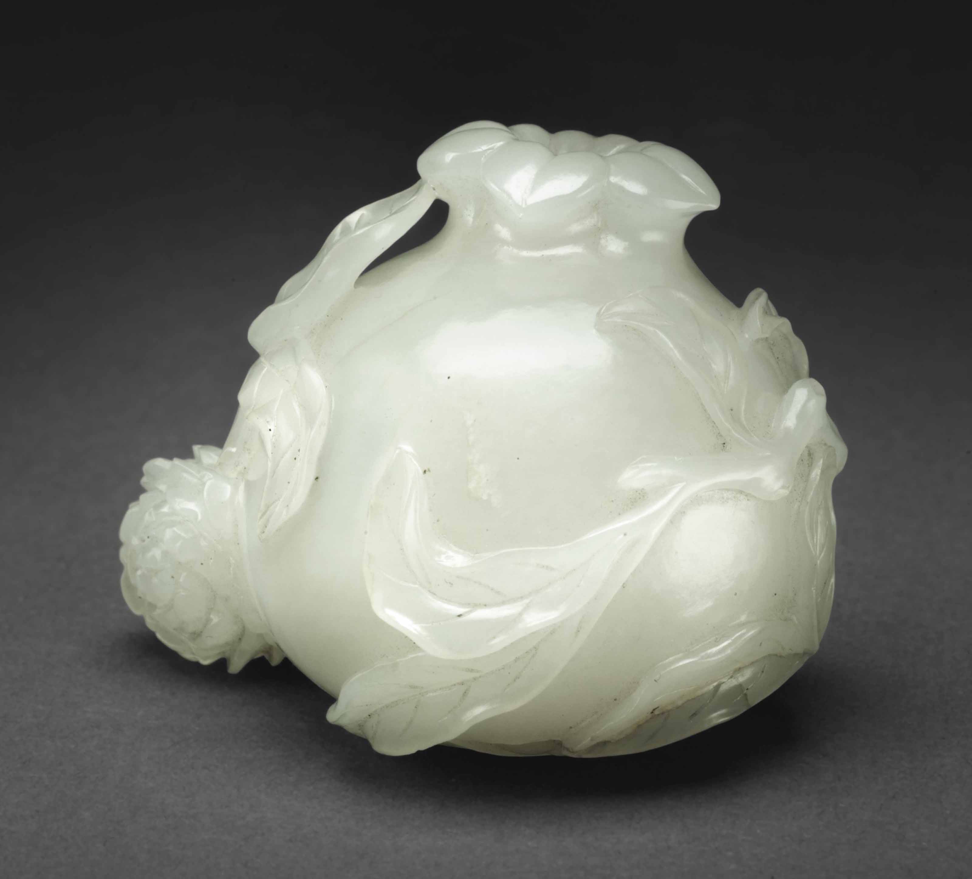 A WHITE JADE CARVING OF A POMEGRANATE