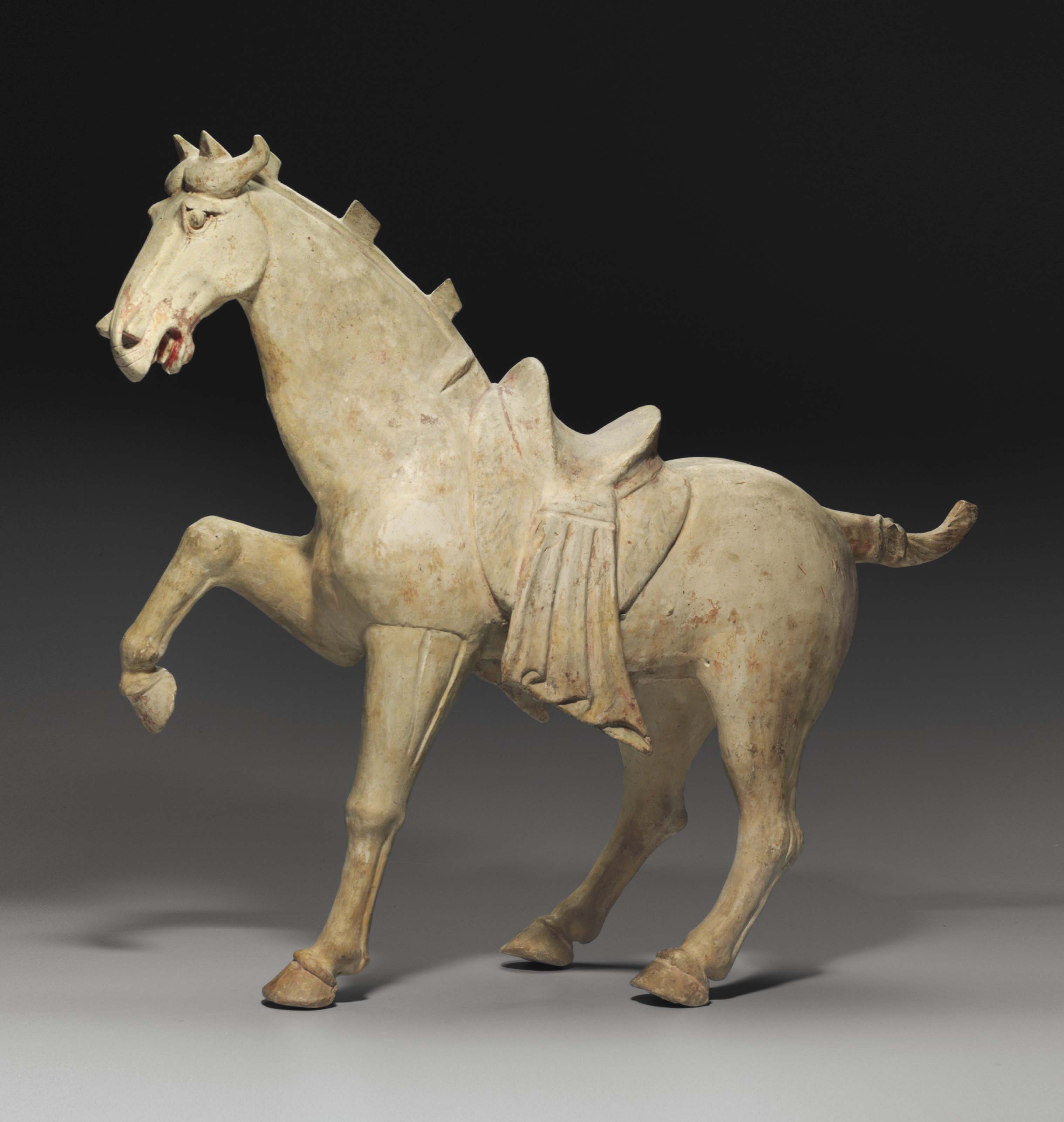 A LARGE PAINTED POTTERY FIGURE OF A HORSE , TANG DYNASTY, 8TH CENTURY
