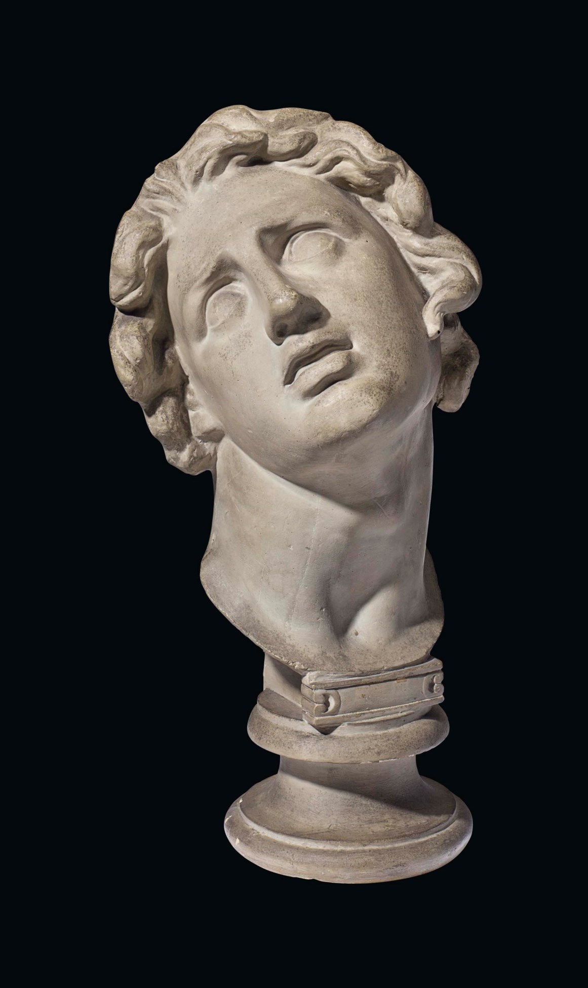 A GREY-PAINTED PLASTER HEAD OF THE DYING ALEXANDER, ATTRIBUTED TO THE ...