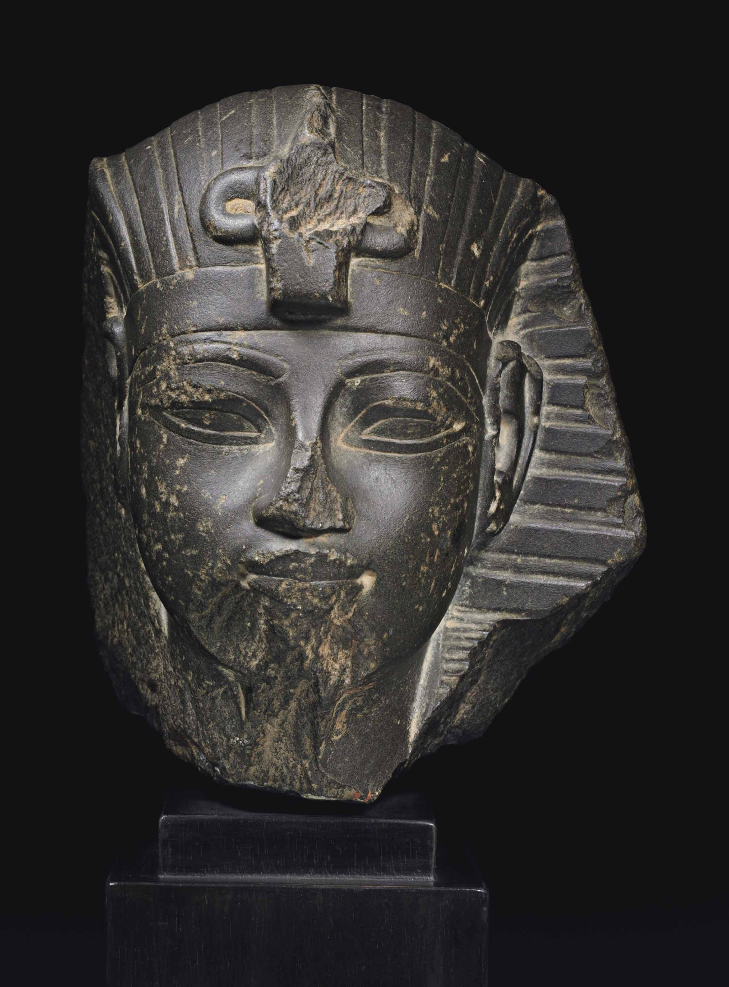 An Egyptian greywacke portrait head of Amenhotep III, New Kingdom, 18th Dynasty, reign of Amenhotep III, 1390-1352 B.C.&nbsp;6&frac14;  in (15.8  cm) high. Estimate: $200,000-300,000. This lot is offered in Antiquities on 25 October 2017  at Christie&rsquo;s in New York