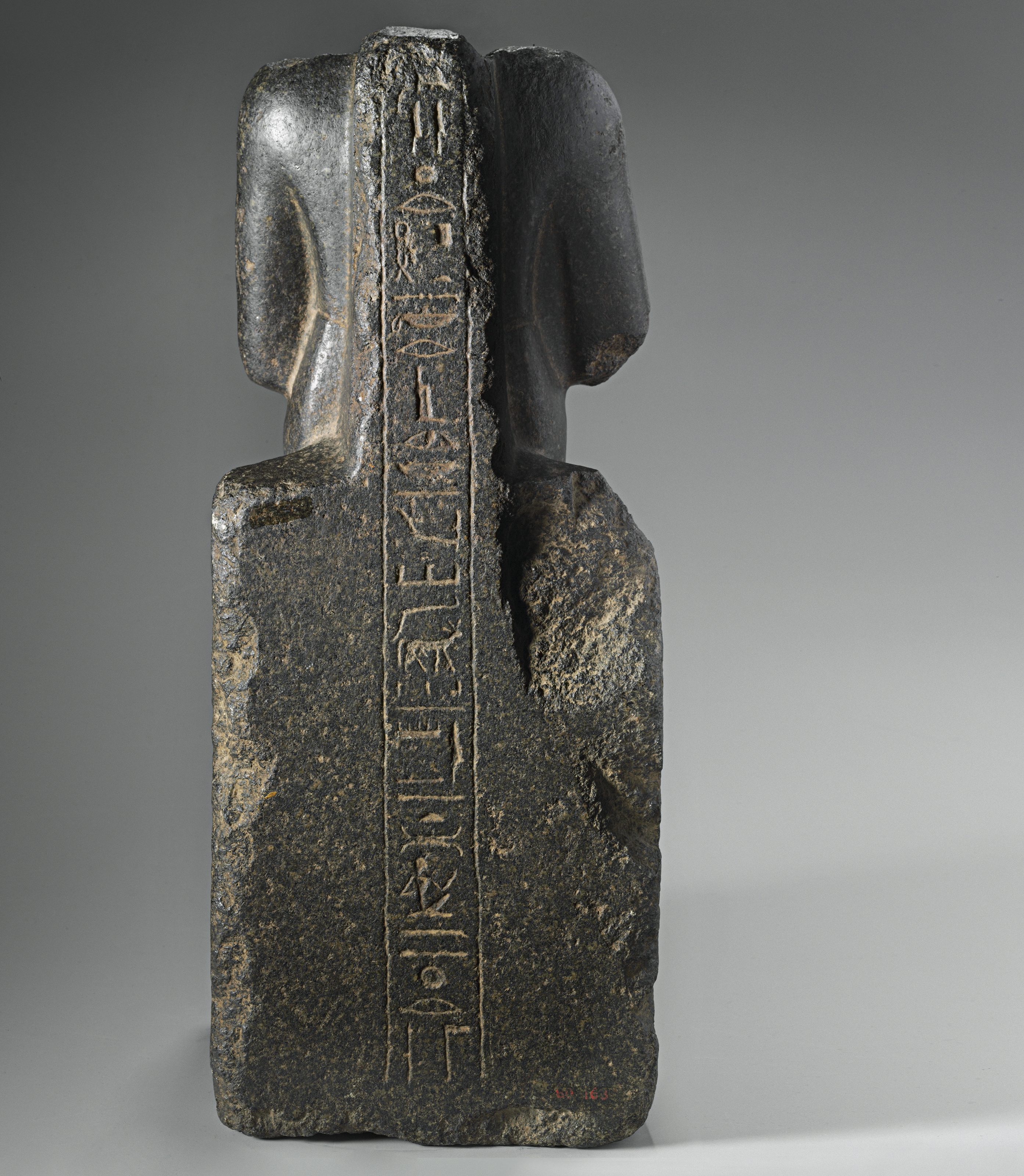 AN EGYPTIAN BLACK GRANITE SEATED SCULPTURE FOR NEITH, OVERSEER OF THE