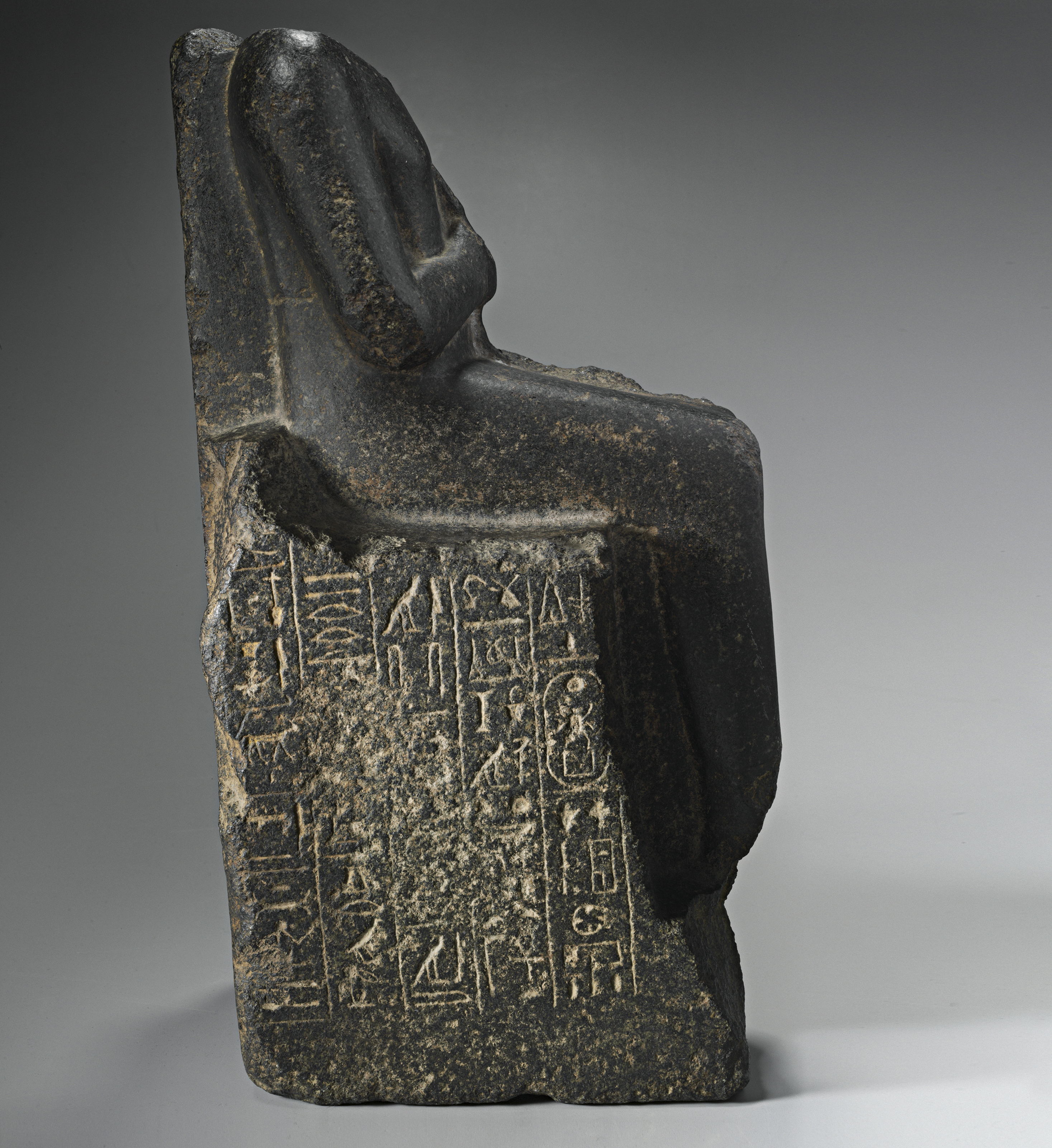 AN EGYPTIAN BLACK GRANITE SEATED SCULPTURE FOR NEITH, OVERSEER OF THE