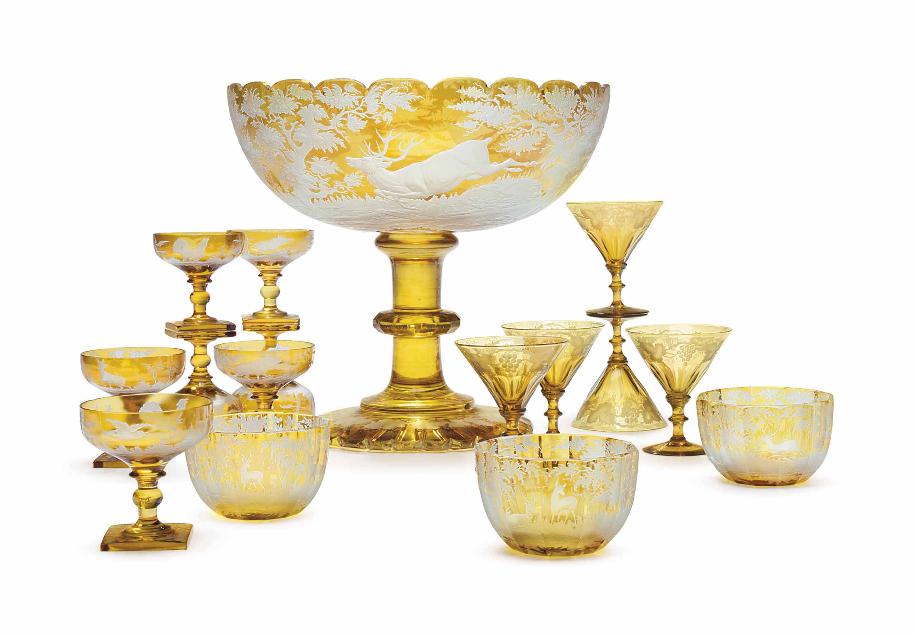 AN ASSEMBLED BOHEMIAN AMBERFLASHED AND ETCHED GLASS DRINKWARE SET