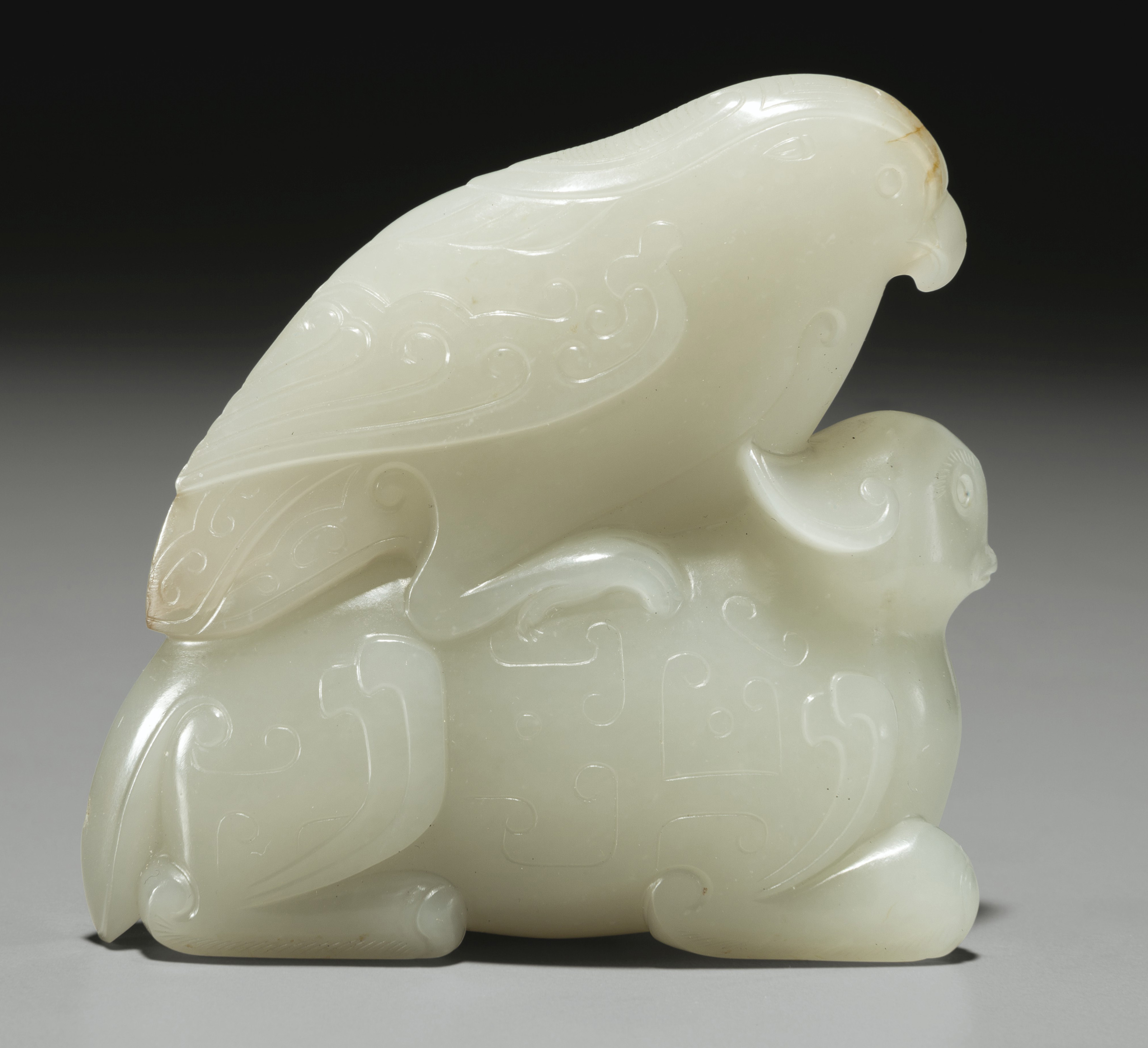 A WHITE JADE CARVING OF A BEAST AND BIRD