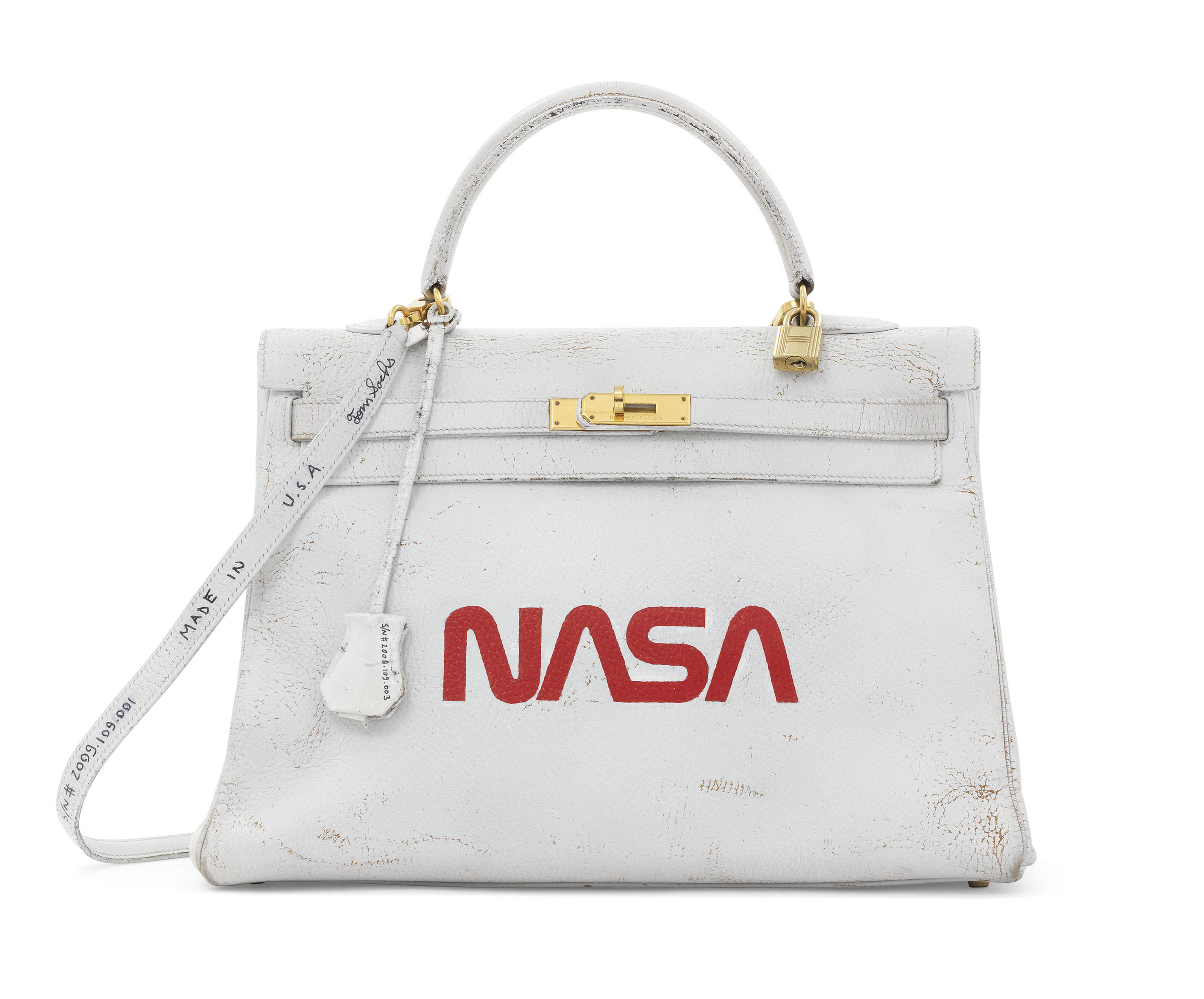 A unique painted White and Red Ardennes leather Nasa Retourne Kelly 35 with gold hardware by Tom Sachs, Hermes, 1996, executed in 2009, sold for £40,000 on 12 June 2018 at Christie's in London