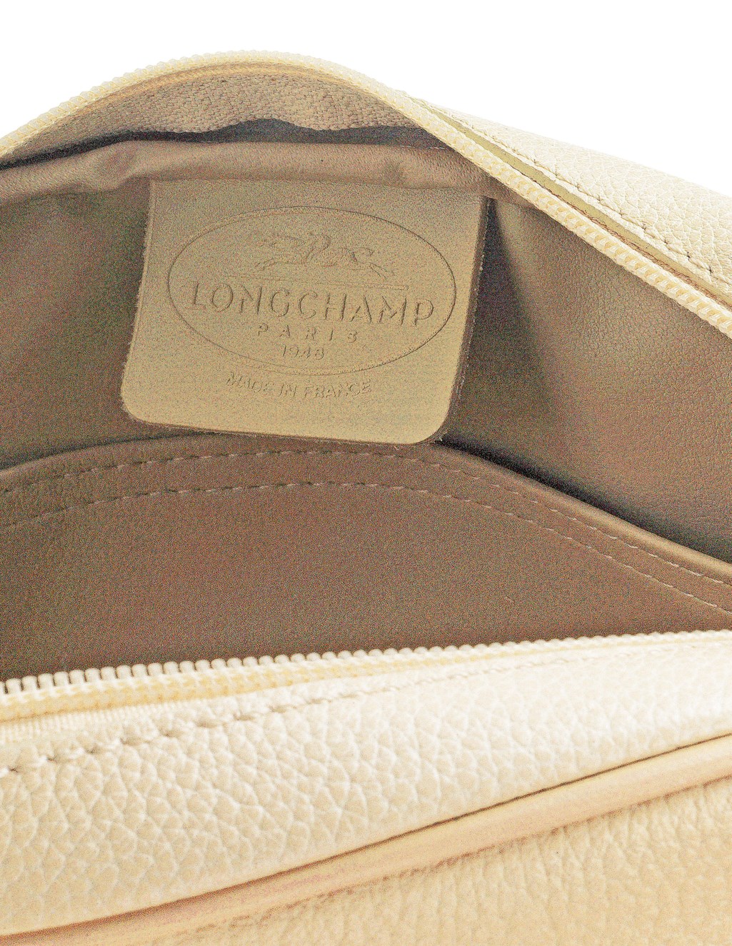 A CREAM STAMPED LEATHER SHOULDER BAG AND A TRAVEL WALLET TOGETHER WITH