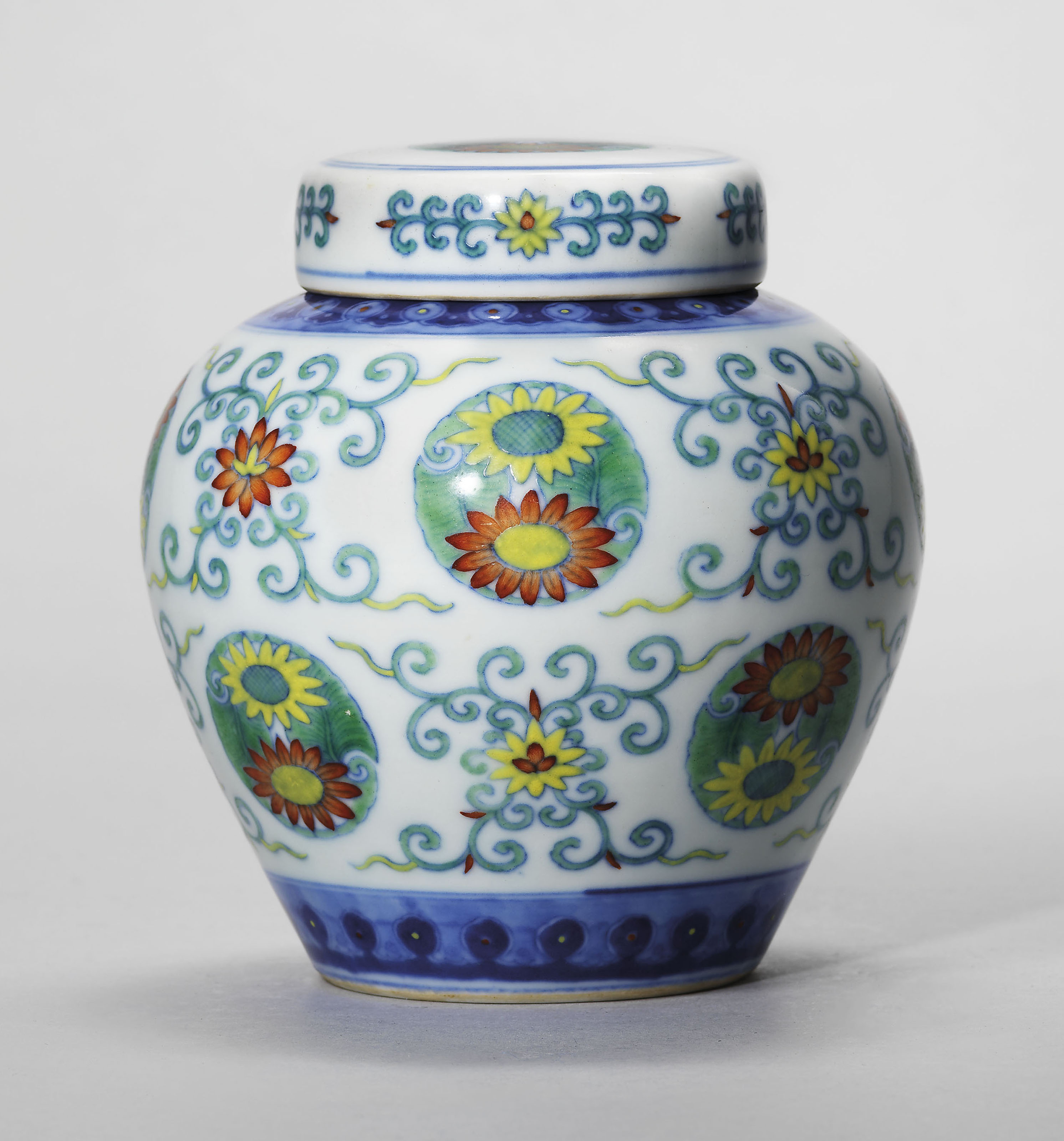A doucai 'chrysanthemum' jar and cover, Qianlong six-character seal mark in underglaze blue and of the period (1736-1795). 4&frac12;  in (11.6  cm) high.