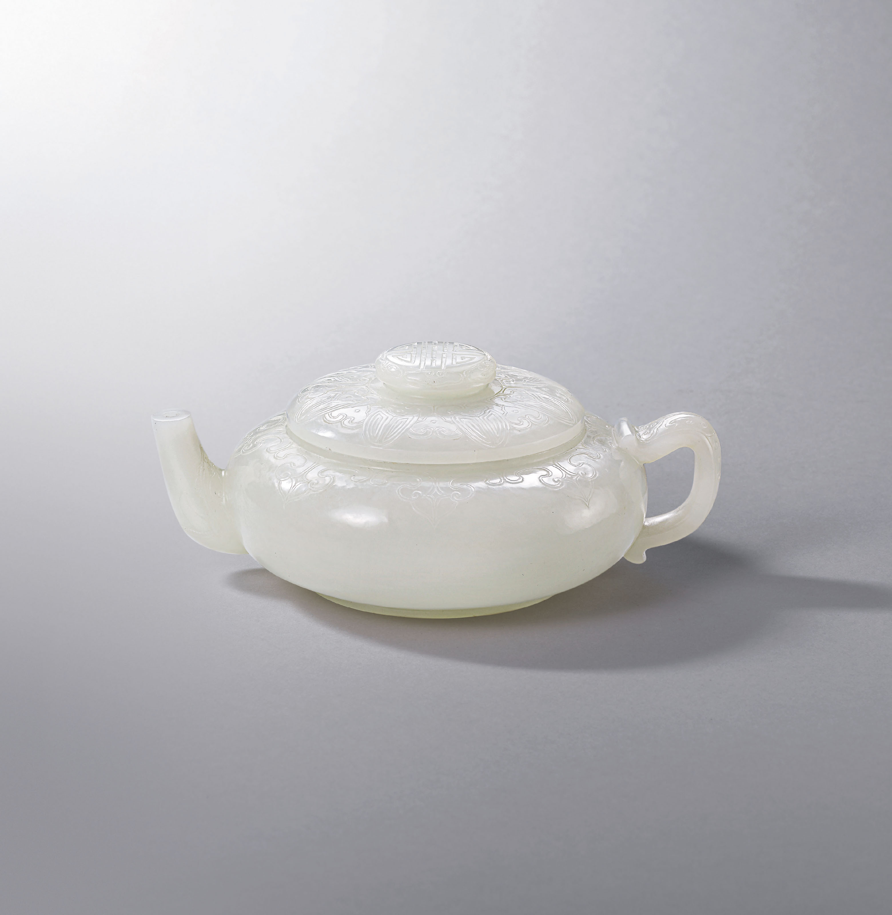 A FINELY CARVED AND RARE WHITE JADE TEAPOT