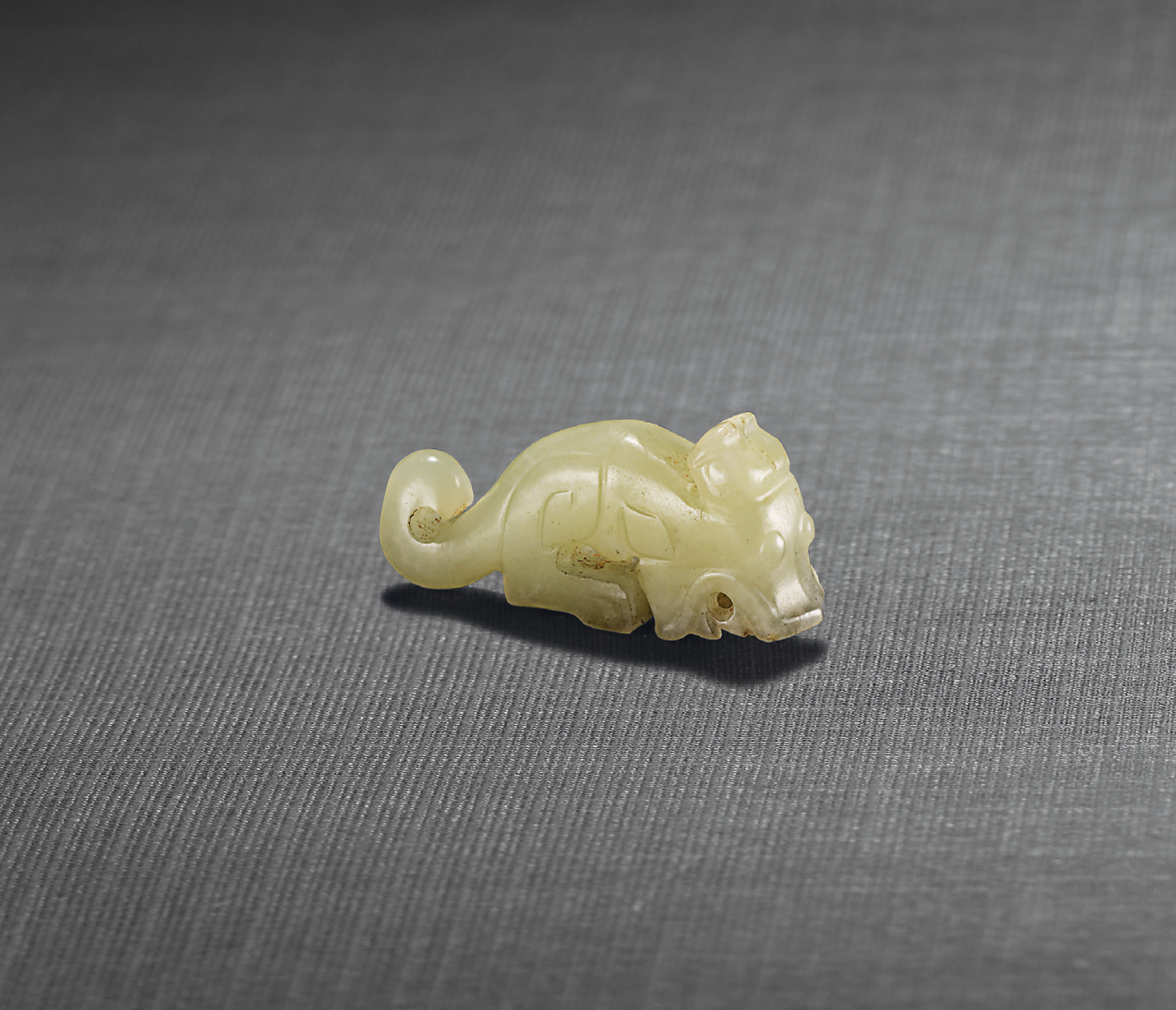 A CELADON JADE ‘DRAGON’ PENDANT , SHANG DYNASTY (C. 16001100 BC