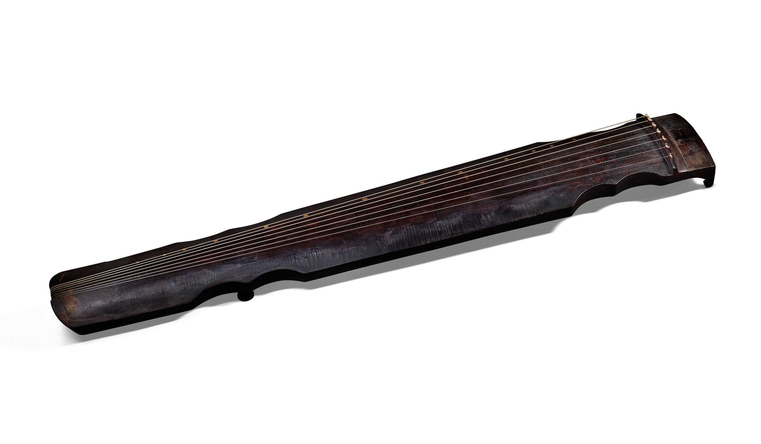 An important lacquered phoenix-style qin, Song dynasty (960-1279). Thickness: 1&frac34;  in (4.4  cm).
