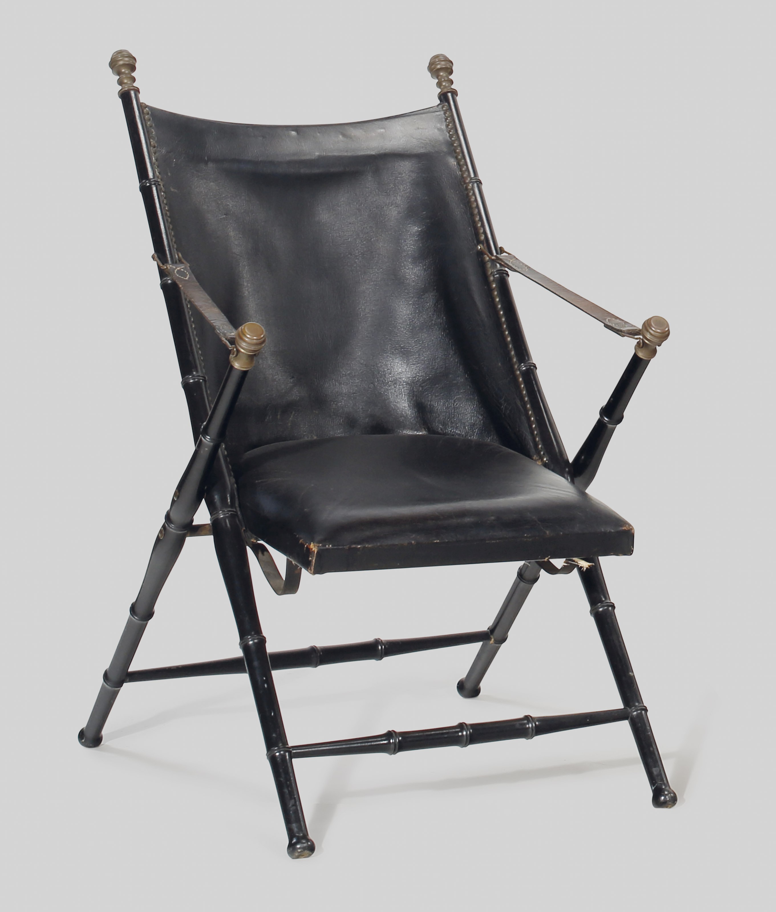 A leather and ebonised folding Campaign chair, second half 20th century, possibly Maison Jansen. 36  in (91.4  cm) high. This lot was offered in the&nbsp;JF Chen Collection on 13 February 2018  at Christie&rsquo;s in New York