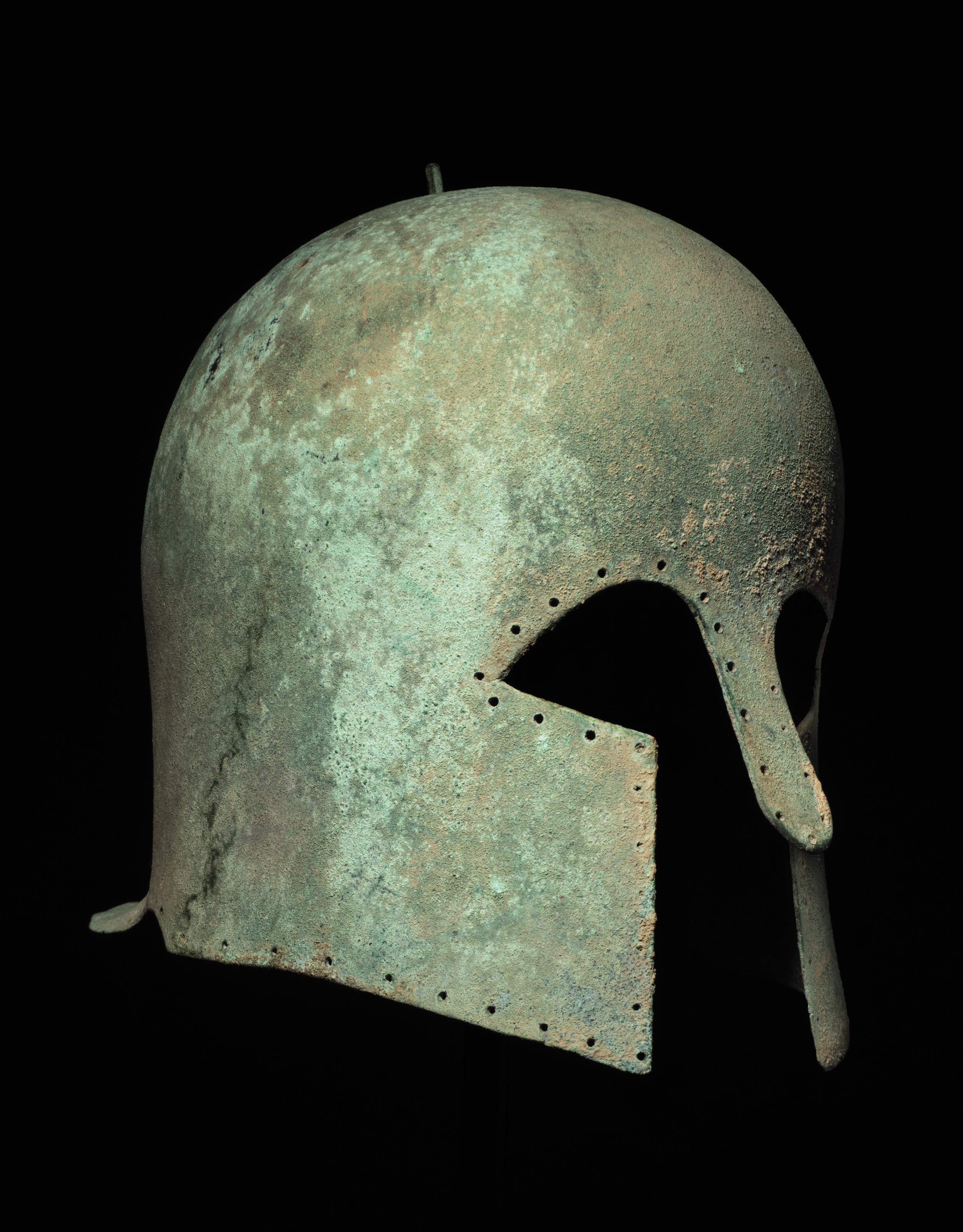 A GREEK BRONZE HELMET OF CORINTHIAN TYPE