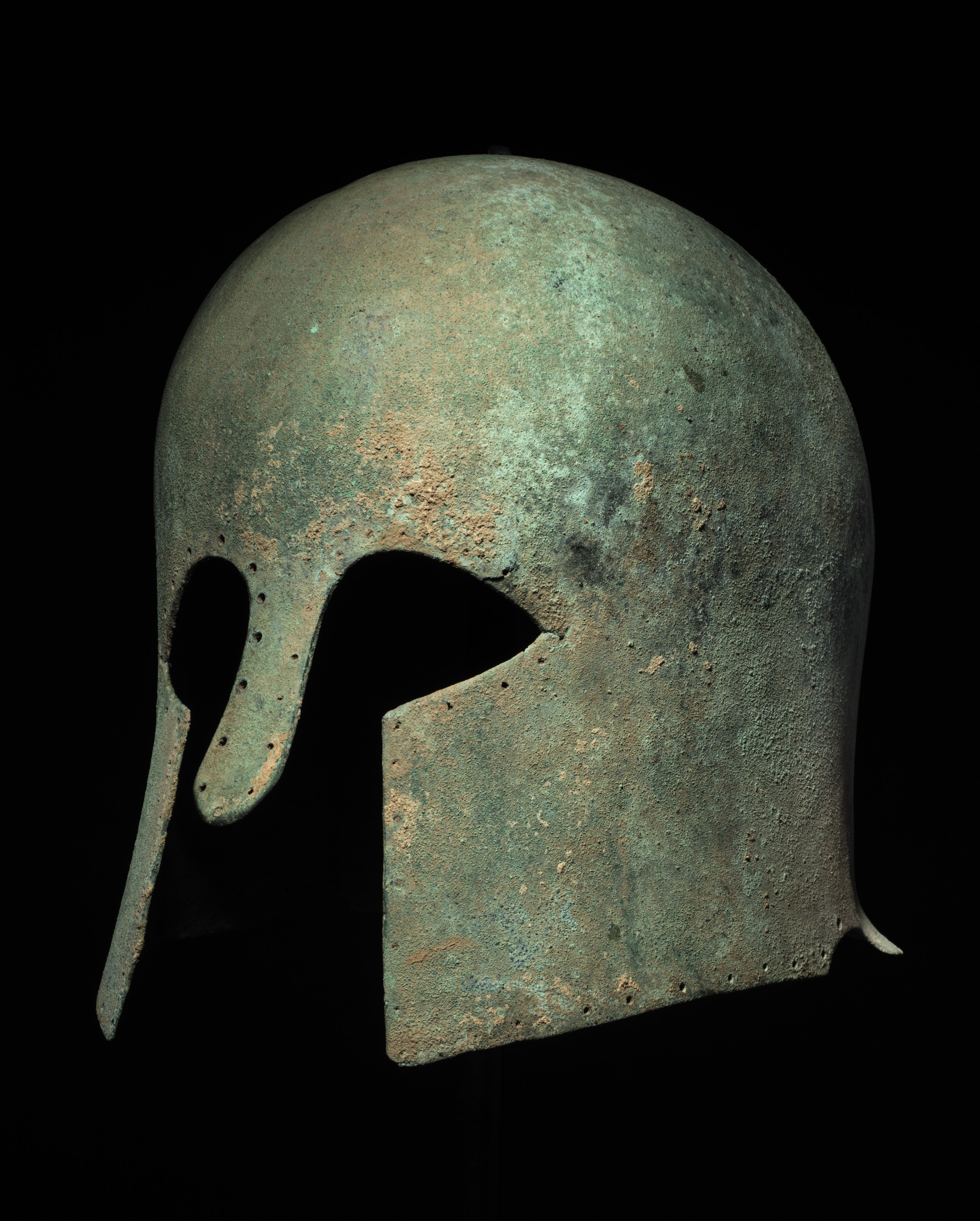 A GREEK BRONZE HELMET OF CORINTHIAN TYPE