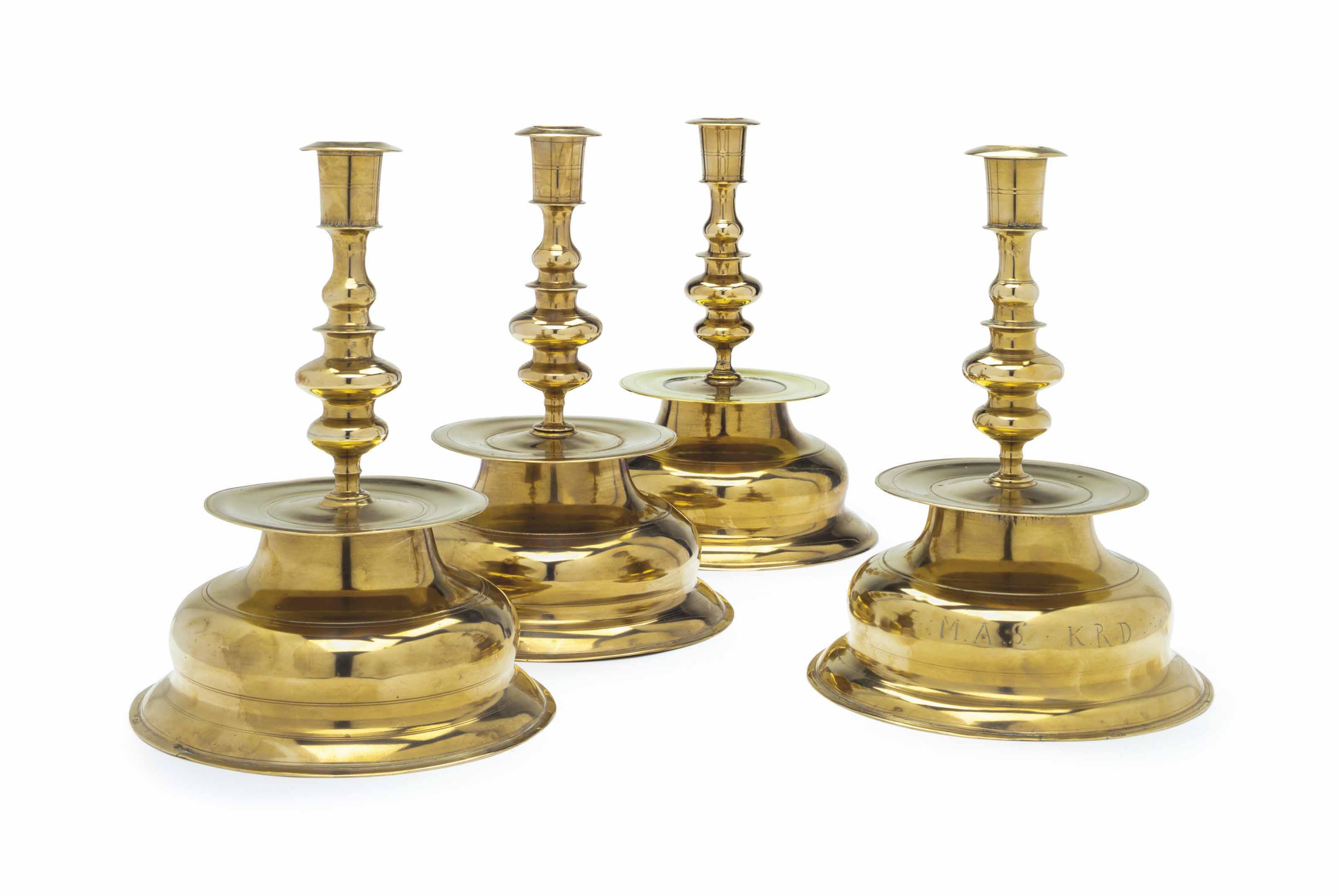 A MATCHED SET OF FOUR GERMAN BRASS CANDLESTICKS , EARLY 18TH CENTURY
