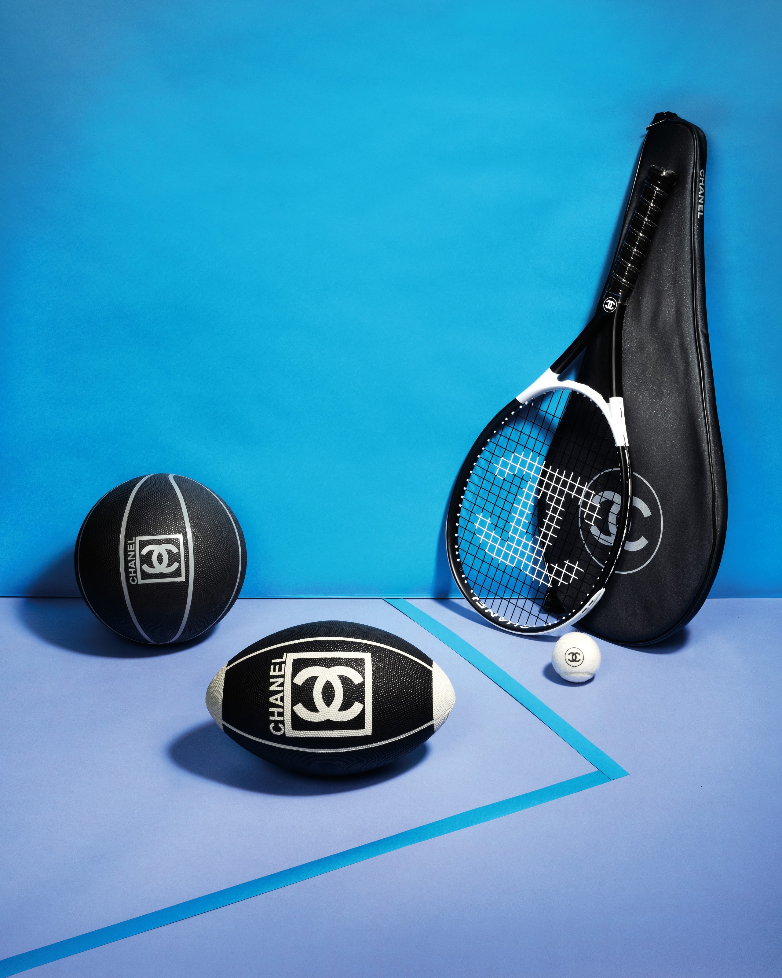 A set of three:
a black rubber basketball, a black rubber rugby ball
a black &amp; white tennis racquet set, Chanel, 2010, 2007, 2011. Estimate: $1,500-2,000. Offered in What Goes Around Comes Around 25th Anniversary Auction on 18 September 2018 at Christie&rsquo;s in New York