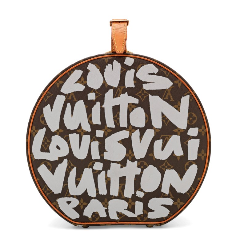 A rare, white monogram Graffiti Boîte Chapeau hat box PM by Stephen Sprouse, Louis Vuitton, 2001. 30 w x 28 h x 16 d cm. Sold for £8,125 on 11 June 2019 at Christie’s in London