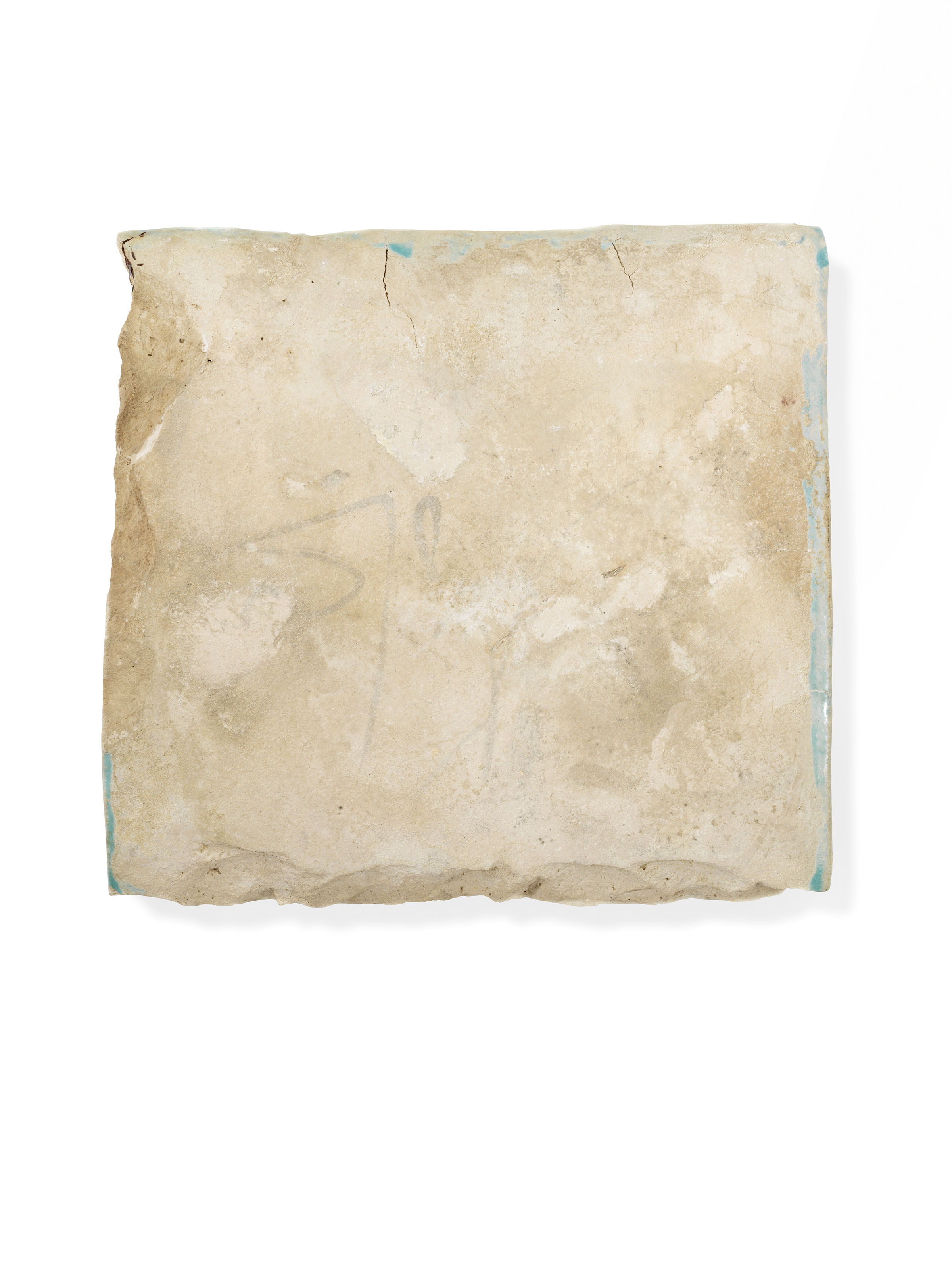 A TURQUOISE AND COBALTBLUE MOULDED CALLIGRAPHIC POTTERY BORDER TILE