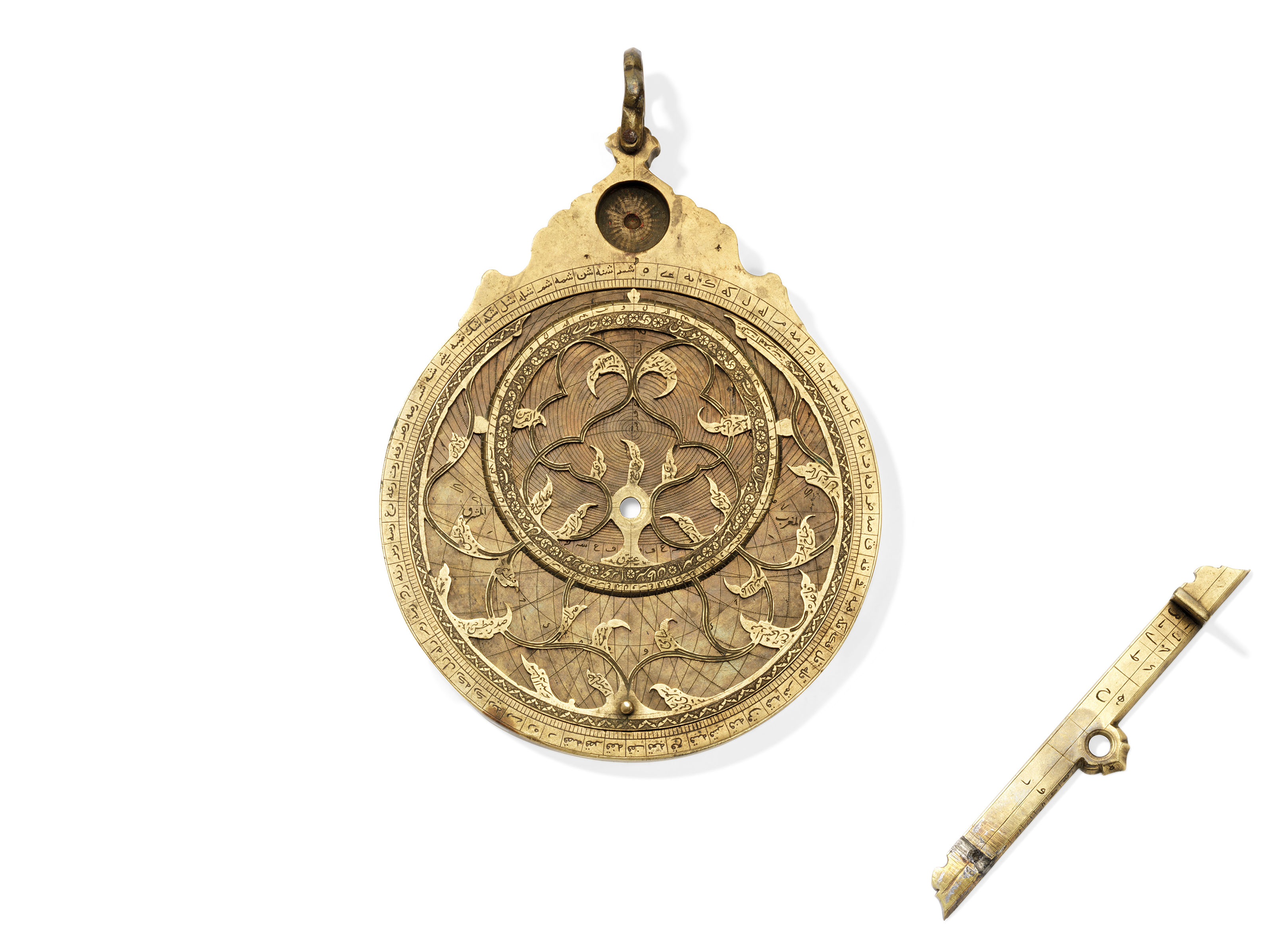 A fine Safavid brass astrolabe, signed Muhammad Zaman al-Munajim al-Mashhadi al-Asturlabi, Mashhad, Iran, 17th century. 6⅞ in (18 cm) high overall; 5⅜ in (14 cm)  diam. Estimate: &pound;100,000-150,000. Offered in Art of the Islamic and Indian Worlds Including Oriental Rugs and Carpets on 2 May 2019 at Christie&rsquo;s in London