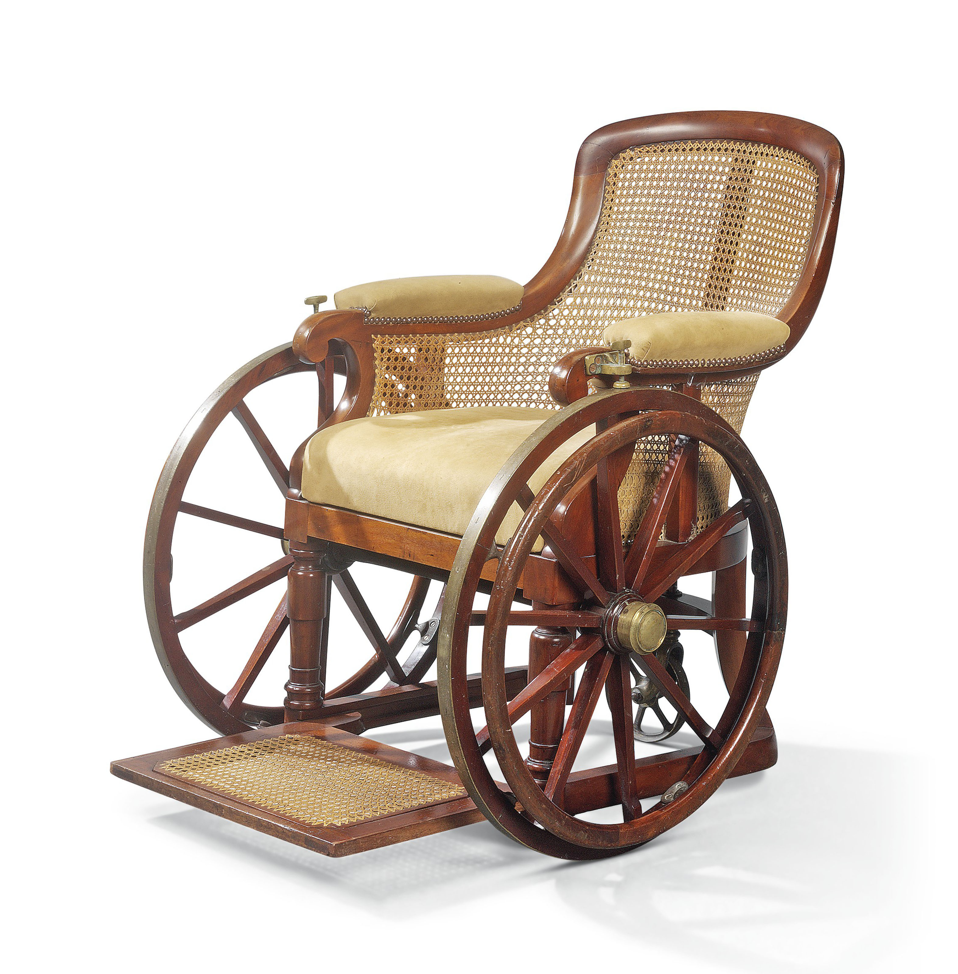 AN EARLY VICTORIAN BRASSMOUNTED MAHOGANY AND CANED WHEELCHAIR