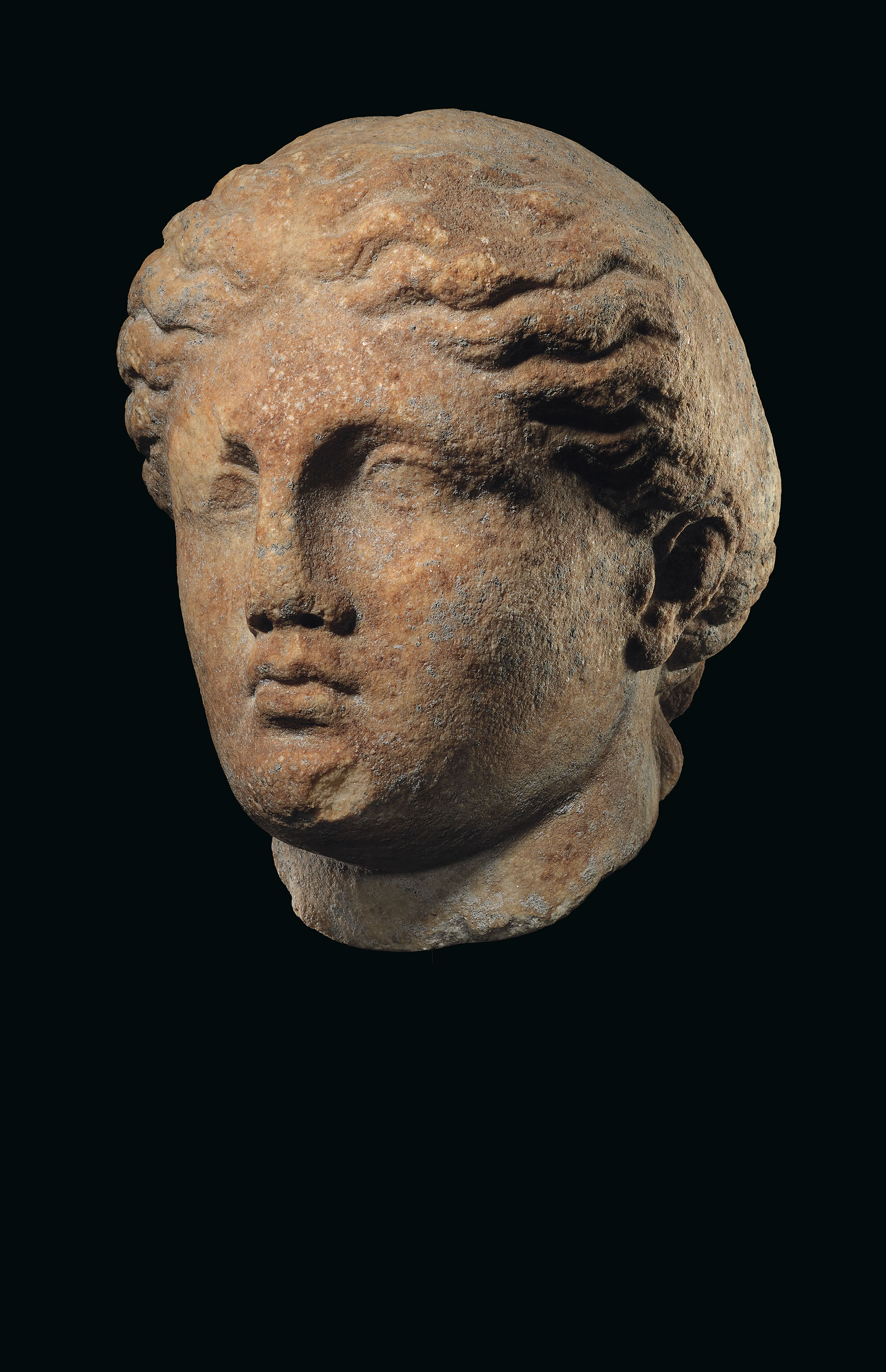 A GREEK MARBLE FEMALE HEAD , CLASSICAL PERIOD, CIRCA 4TH CENTURY B.C