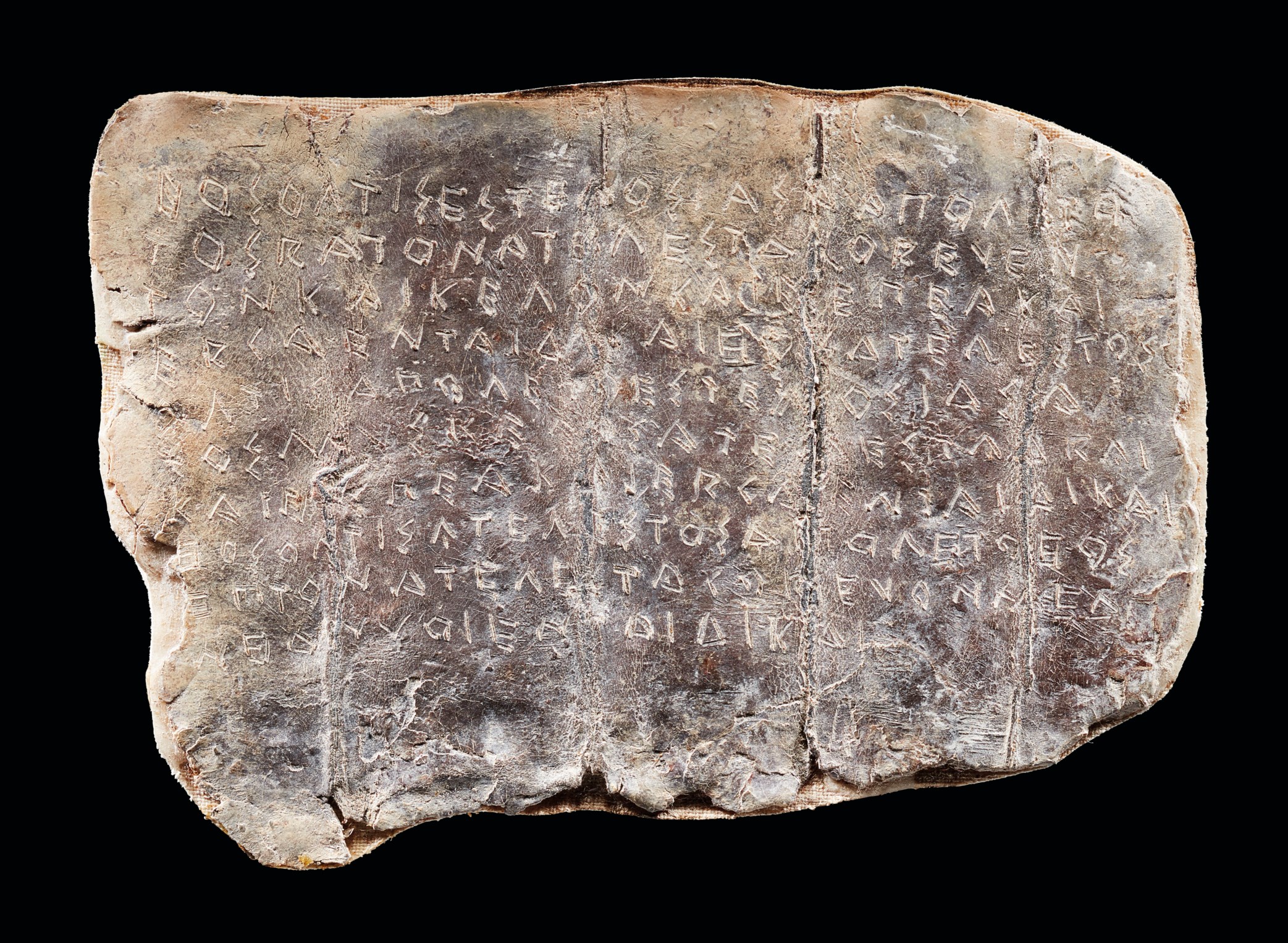A DORIC GREEK INSCRIBED LEAD CURSE TABLET, CIRCA 5TH CENTURY B.C