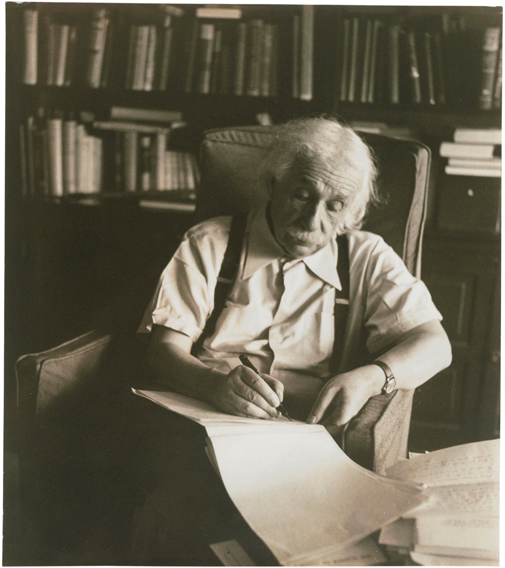 Deep in thought in his study, Albert Einstein. c.1950 Christie’s