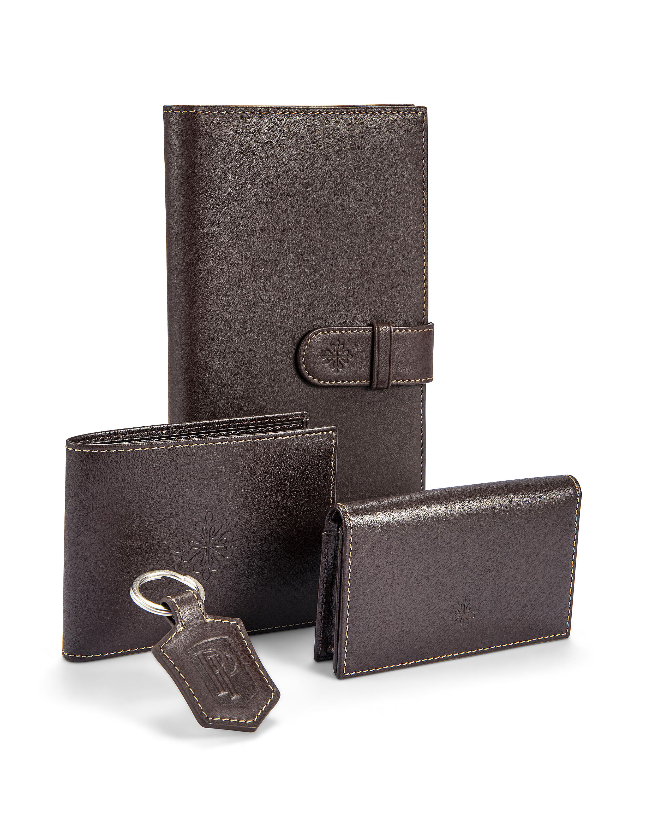 PATEK PHILIPPE. A SET OF BROWN LEATHER ACCESSORIES, | Christie's