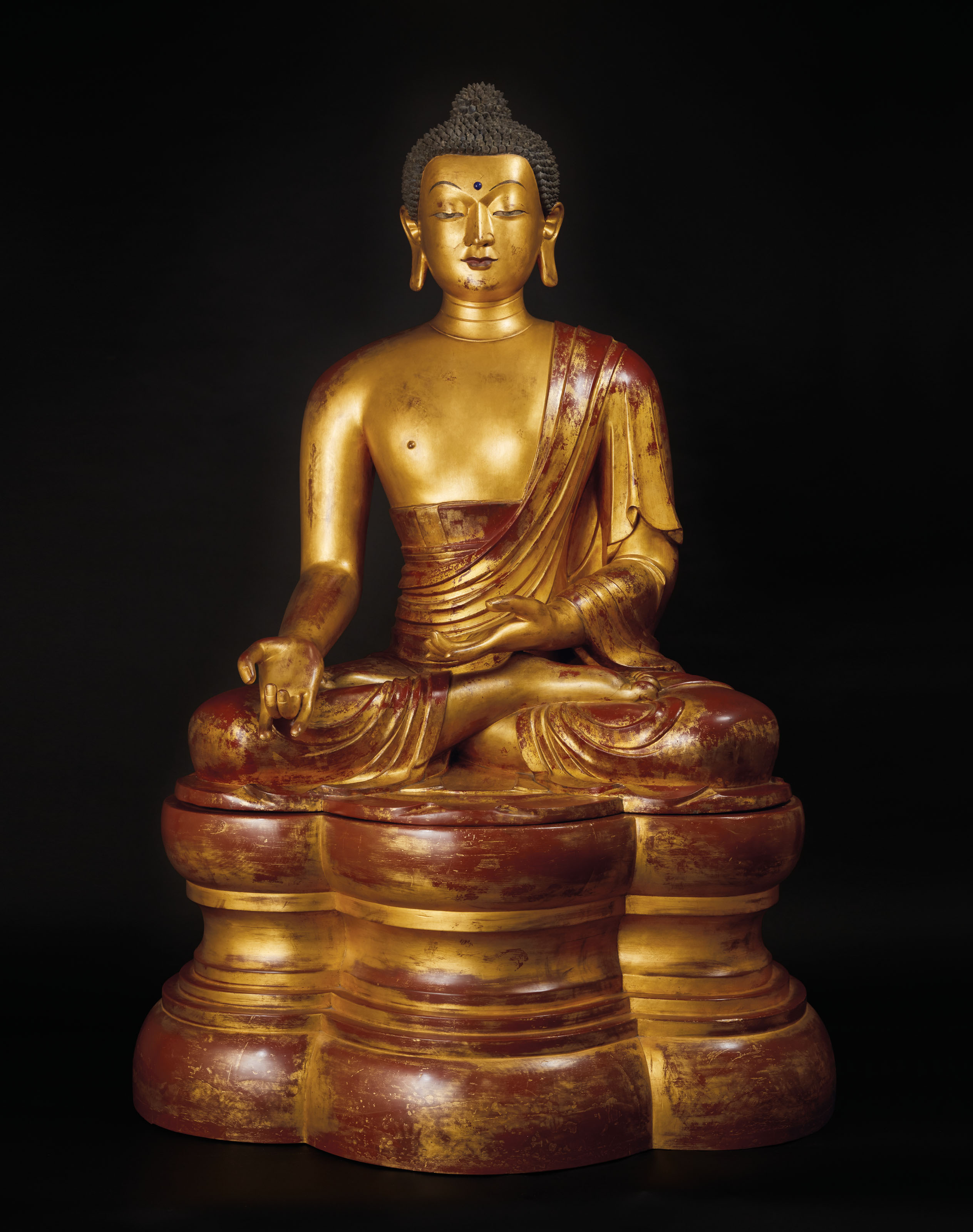 a highly important and monumental imperial gilt lacquered wood figure of the medicine buddha