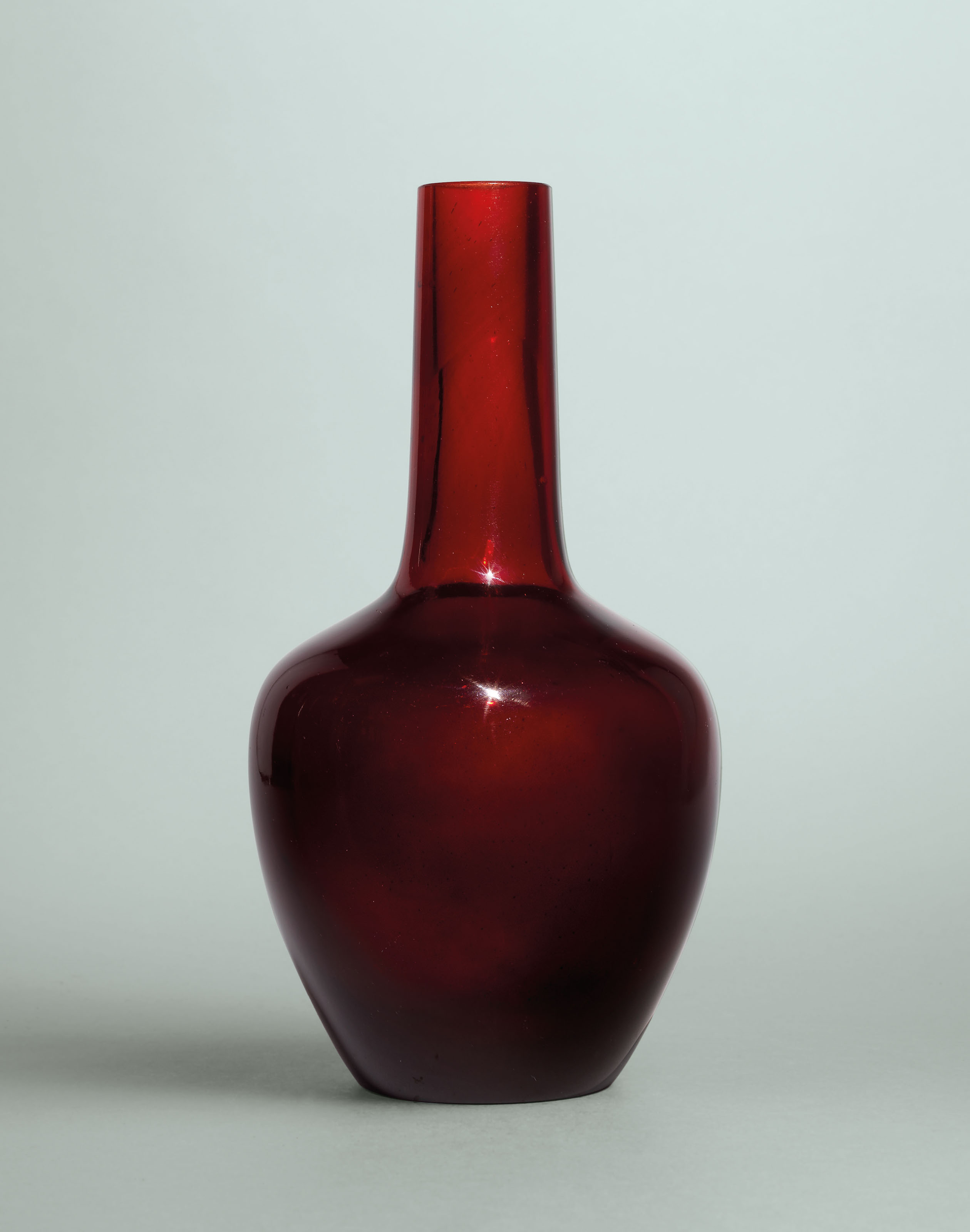 A RUBYRED GLASS BOTTLE VASE , QIANLONG WHEELCUT FOURCHARACTER MARK