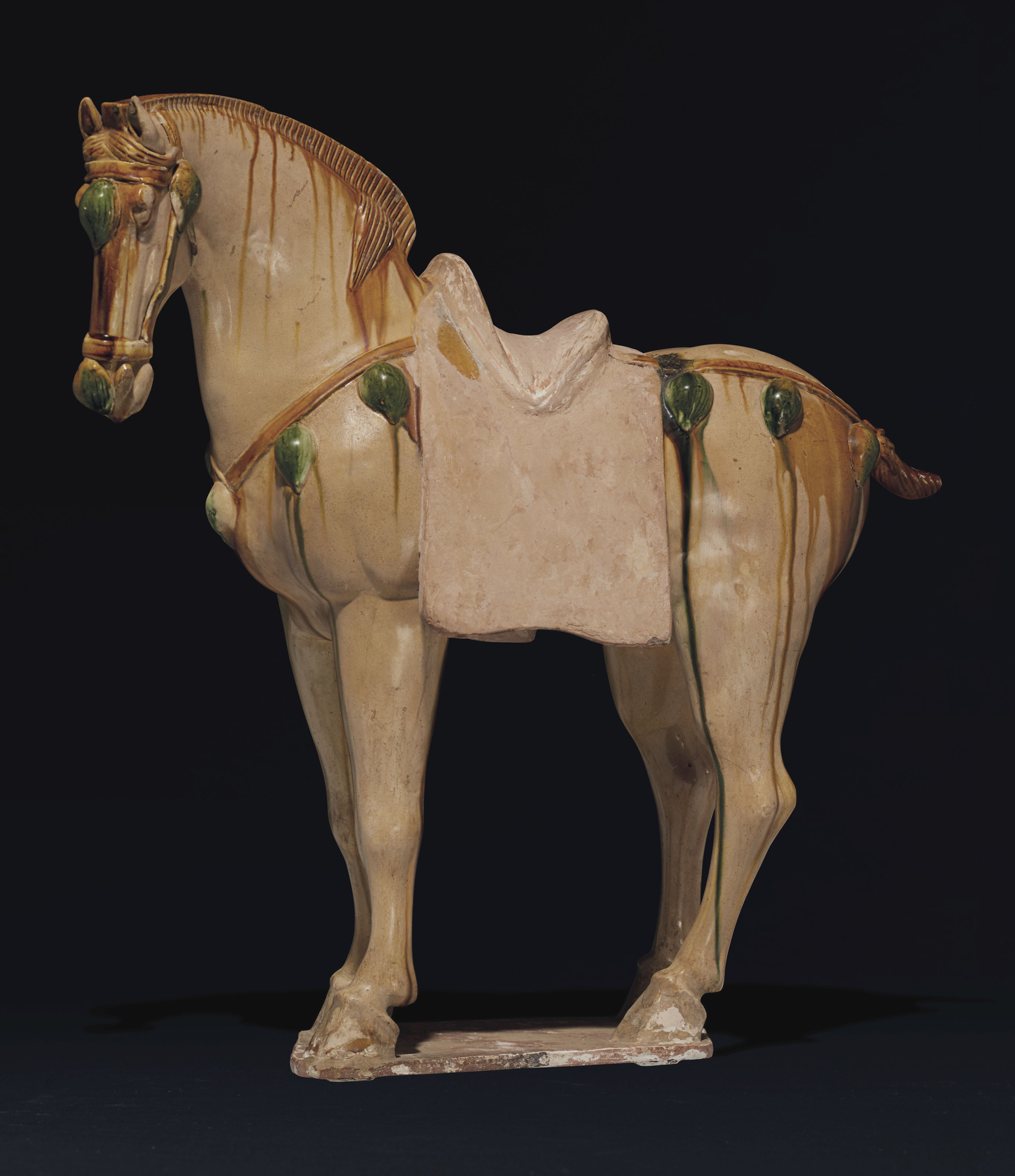 A LARGE SANCAIGLAZED POTTERY FIGURE OF A HORSE , TANG DYNASTY (AD 618