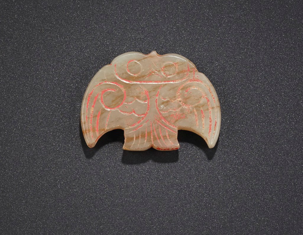 A RARE GREYISH-WHITE JADE OWL-FORM PENDANT