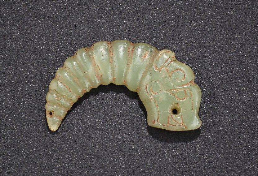 A RARE GREENISH-YELLOW JADE DRAGON-SILKWORM PENDANT