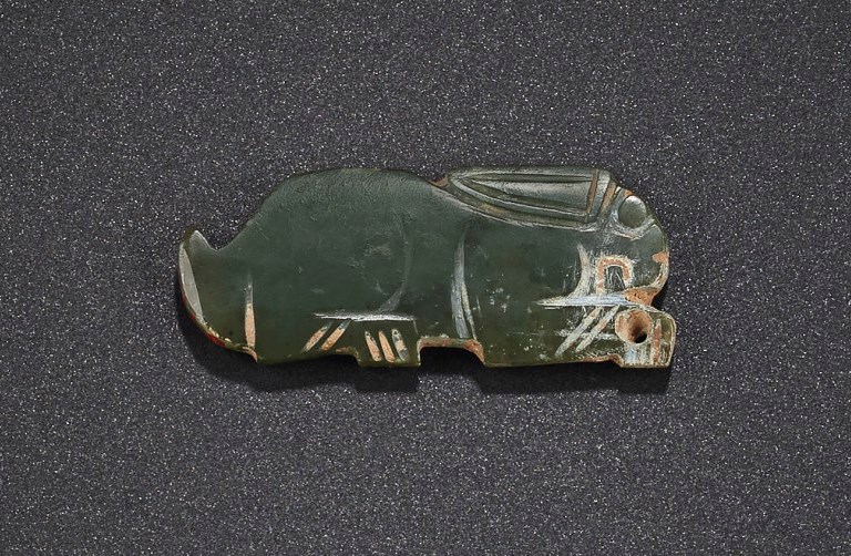 A PALE GREYISH-GREEN JADE RABBIT-FORM PENDANT