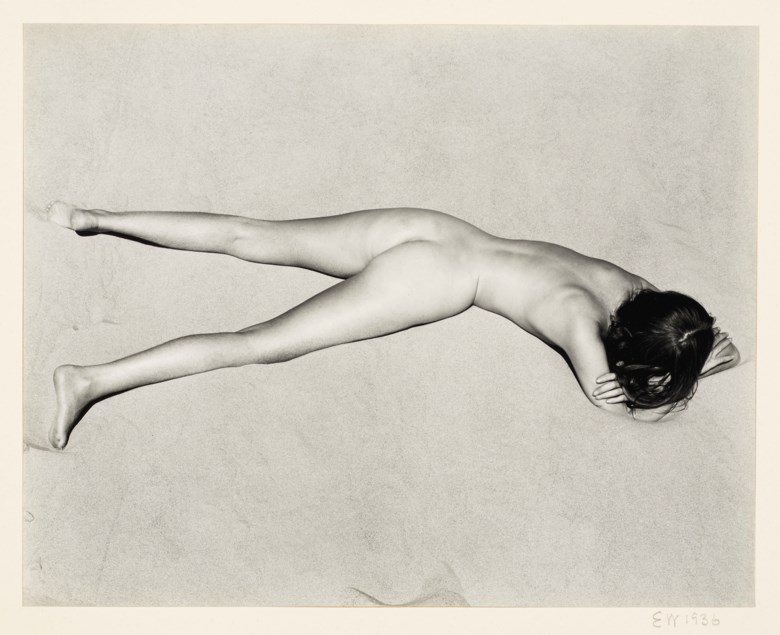 Edward Weston (1886–1958), Nude on Sand, 1936. Gelatin silver print, mounted on card, printed 1940s. Mount 14 x 15½  in (35.5 x 39.3  cm). Estimate $70,000-90,000. This lot is offered in Photographs on 2 April 2019 at Christie’s in New York