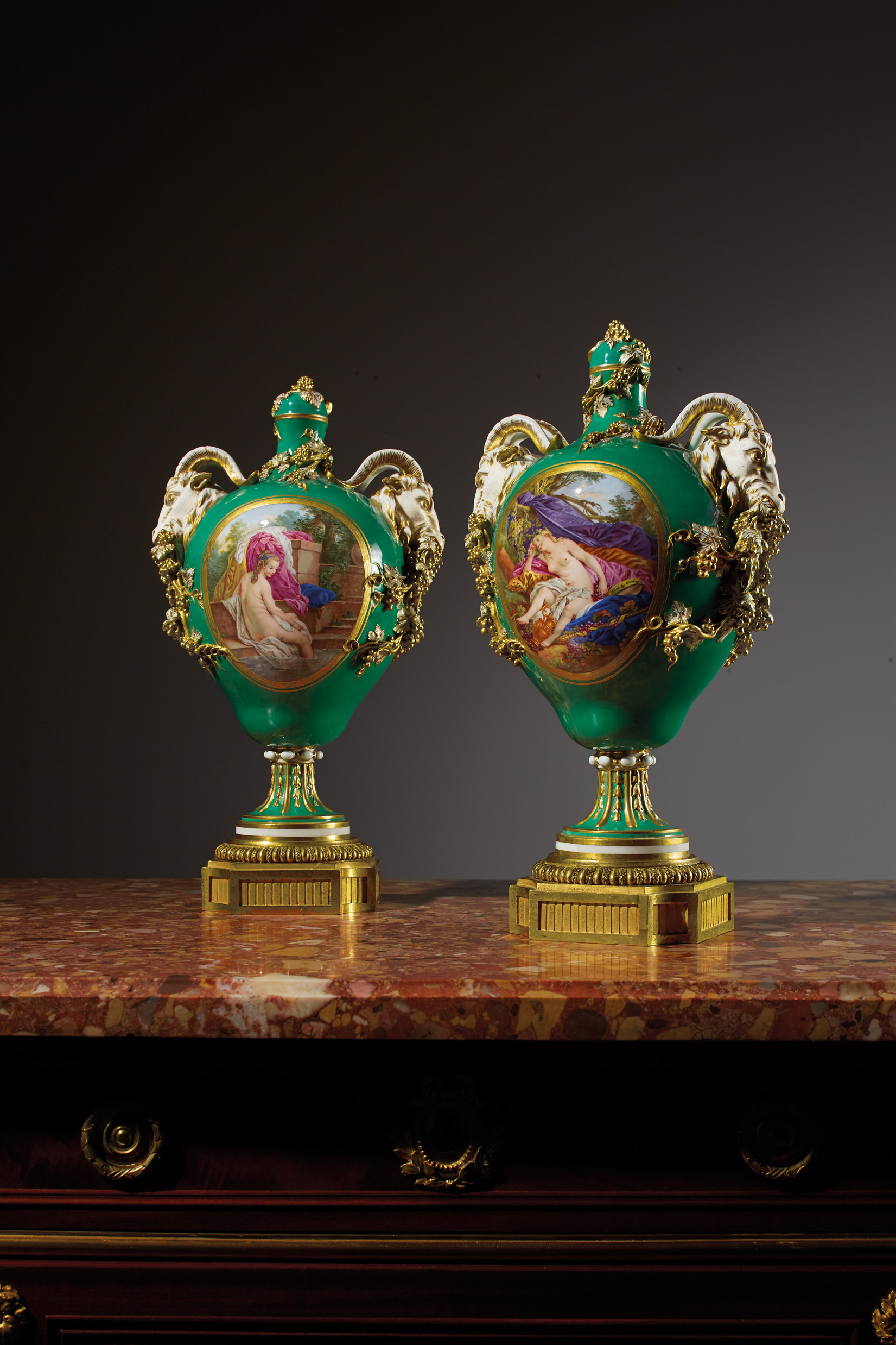 A PAIR OF ORMOLU-MOUNTED SEVRES PORCELAIN GREEN-GROUND VASES AND