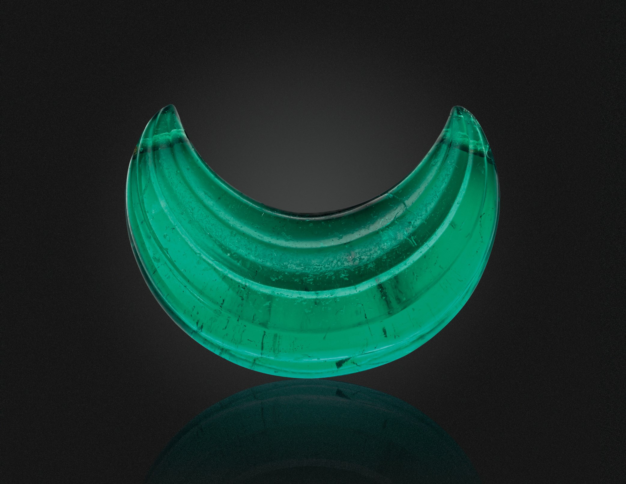 A CARVED EMERALD