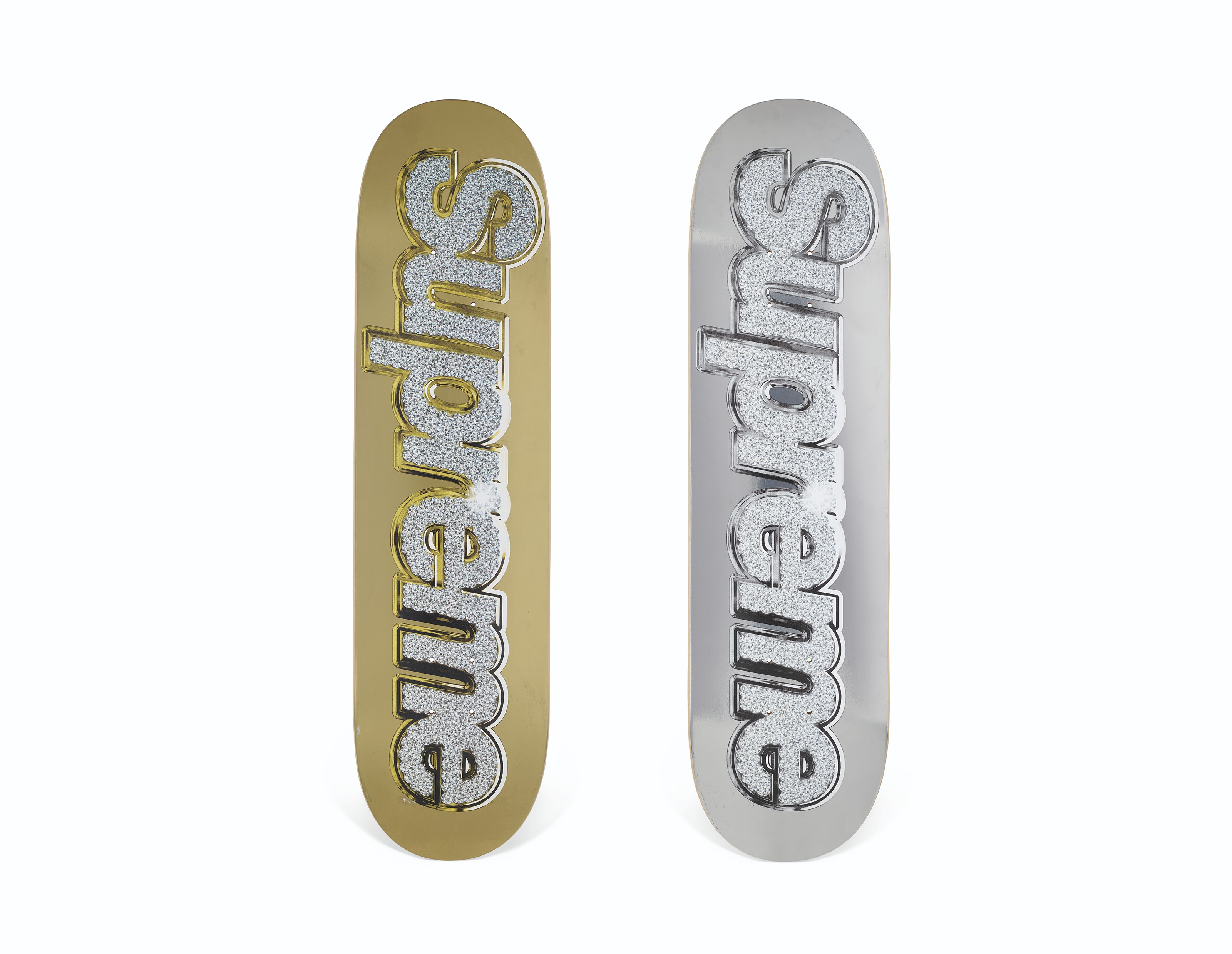 A SET OF TWO SILVER GOLD BLING BOX LOGO SKATEBOARDS SUPREME