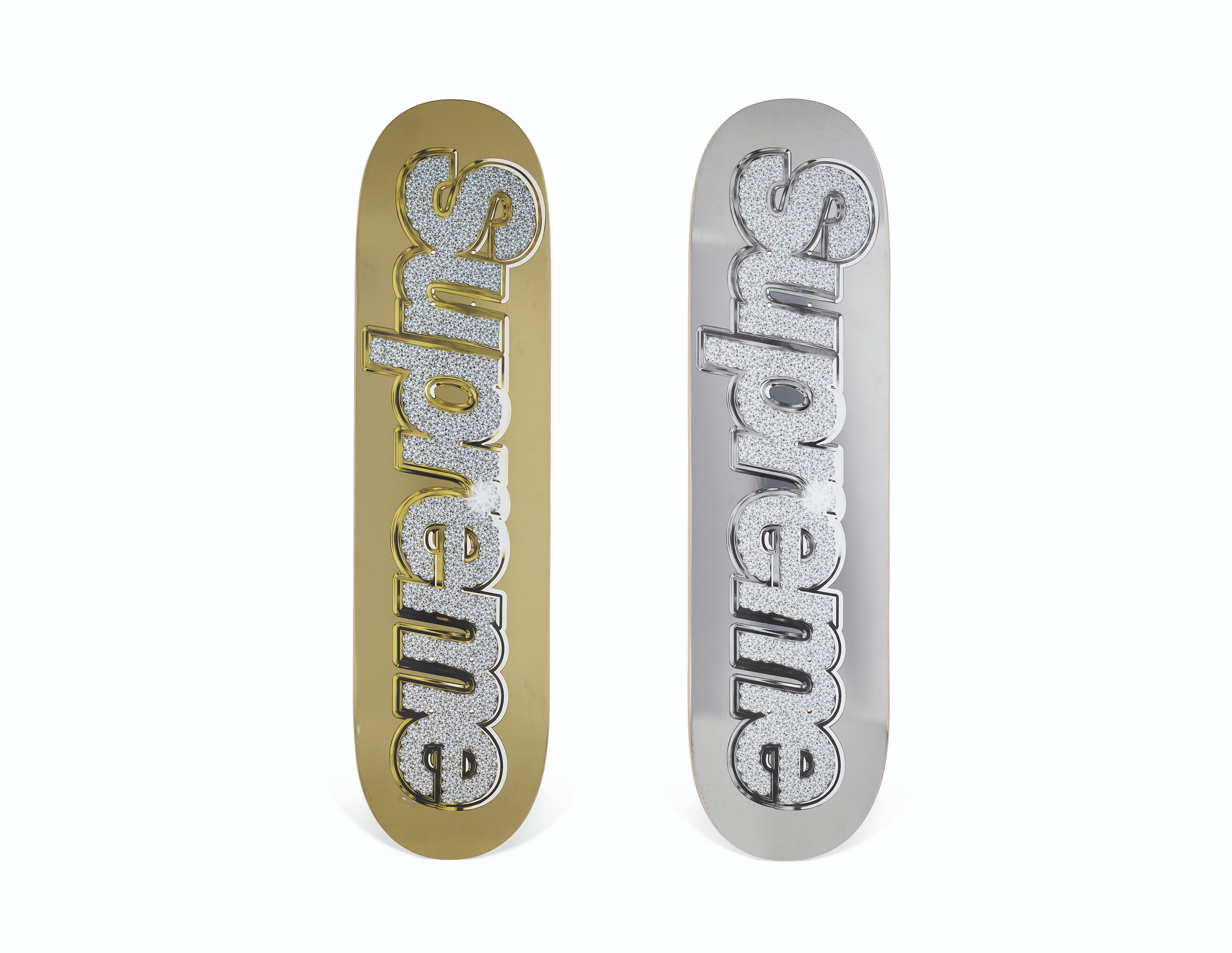 A SET OF TWO SILVER & GOLD BLING BOX LOGO SKATEBOARDS, SUPREME