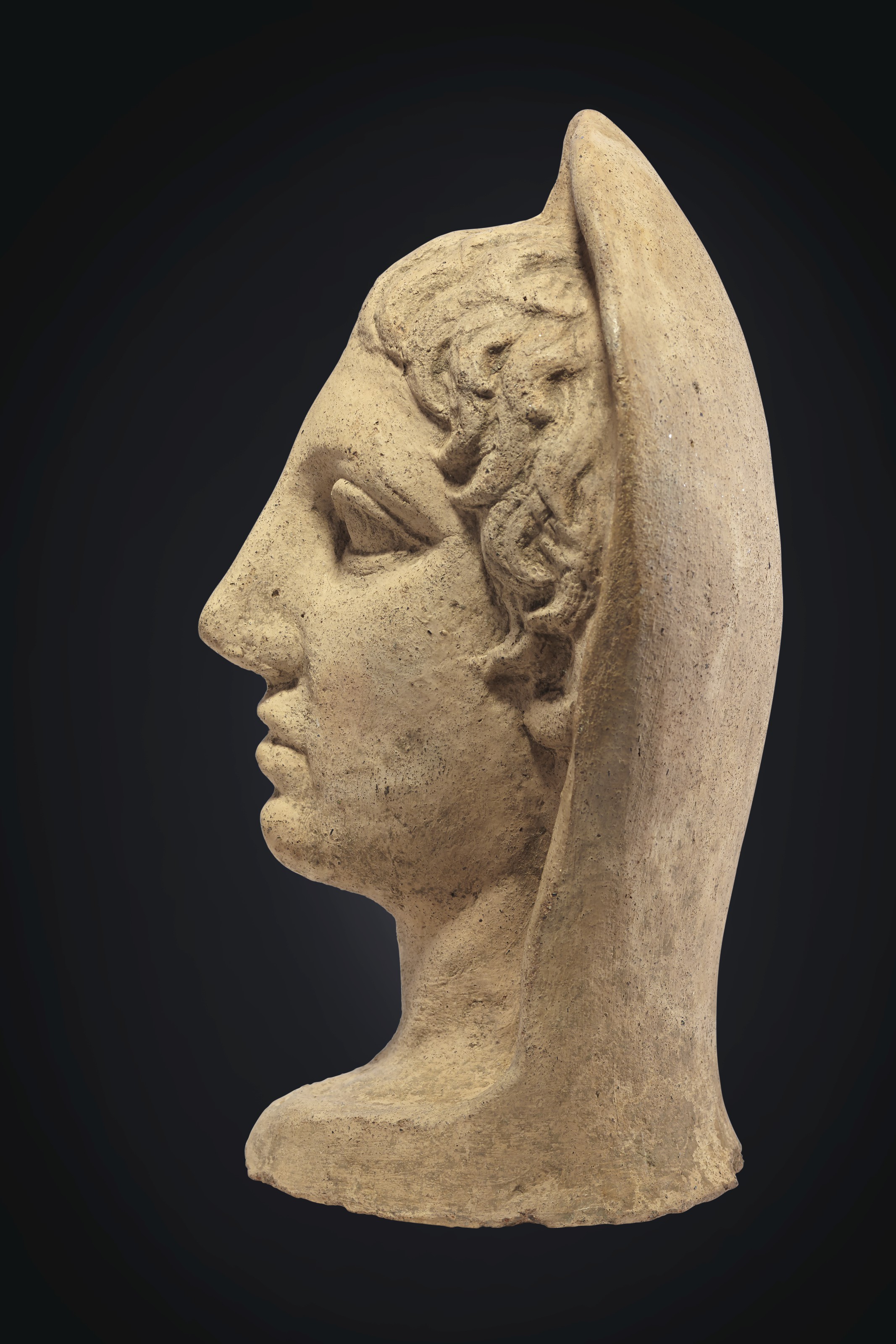 AN ETRUSCAN TERRACOTTA VOTIVE MALE HALFHEAD , CIRCA 4TH3RD CENTURY B