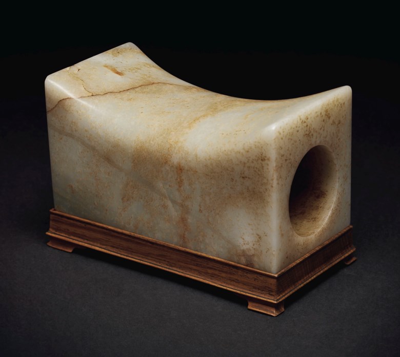 A mottled pale greenish-white and russet jade rectangular pillow, China, Ming dynasty (1368-1644) or later. 6⅞  in (17.4  cm) long. Sold for $60,000 on 20 March 2019 at Christie’s in New York