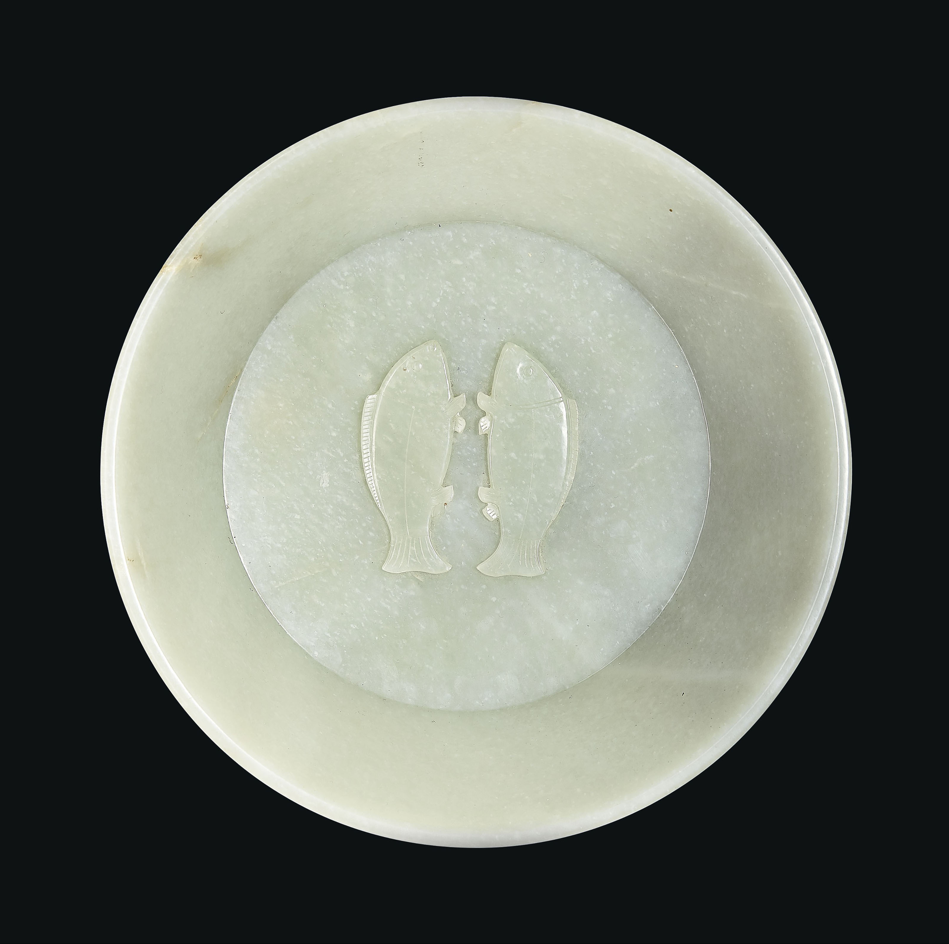 An important and extremely rare imperially inscribed greenish-white jade &lsquo;Twin Fish&rsquo; washer, China, Qing Dynasty, 1786. Diameter 10  in (25.4  cm), hongmu stand. Sold for $2,895,000 on 20 March 2019 at Christie&rsquo;s in New York