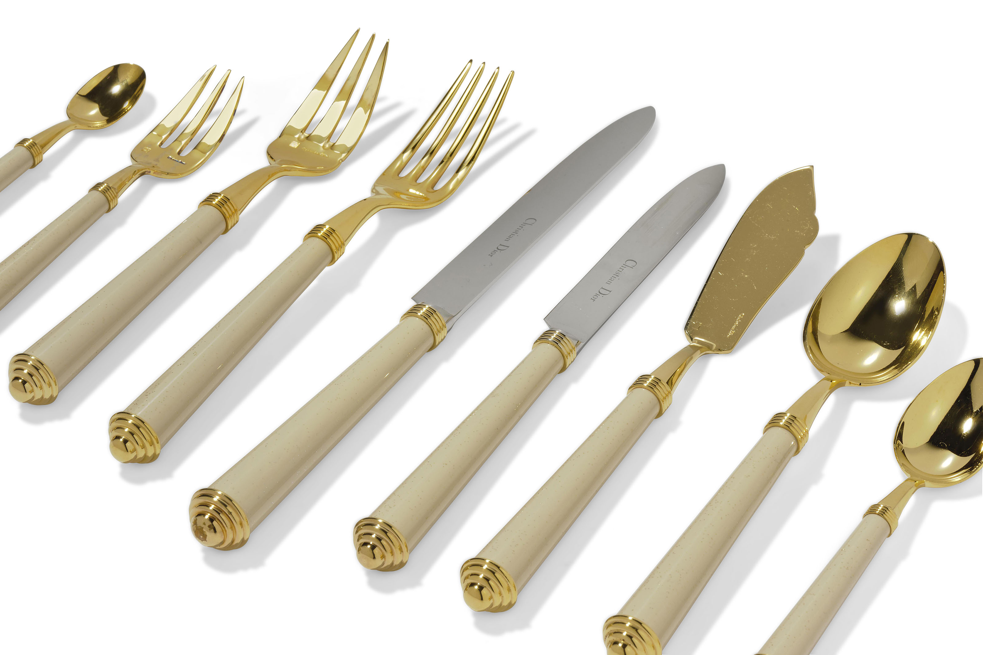 A CHRISTIAN DIOR ENAMELLED METAL HANDLED AND PARCEL-GILT FLATWARE