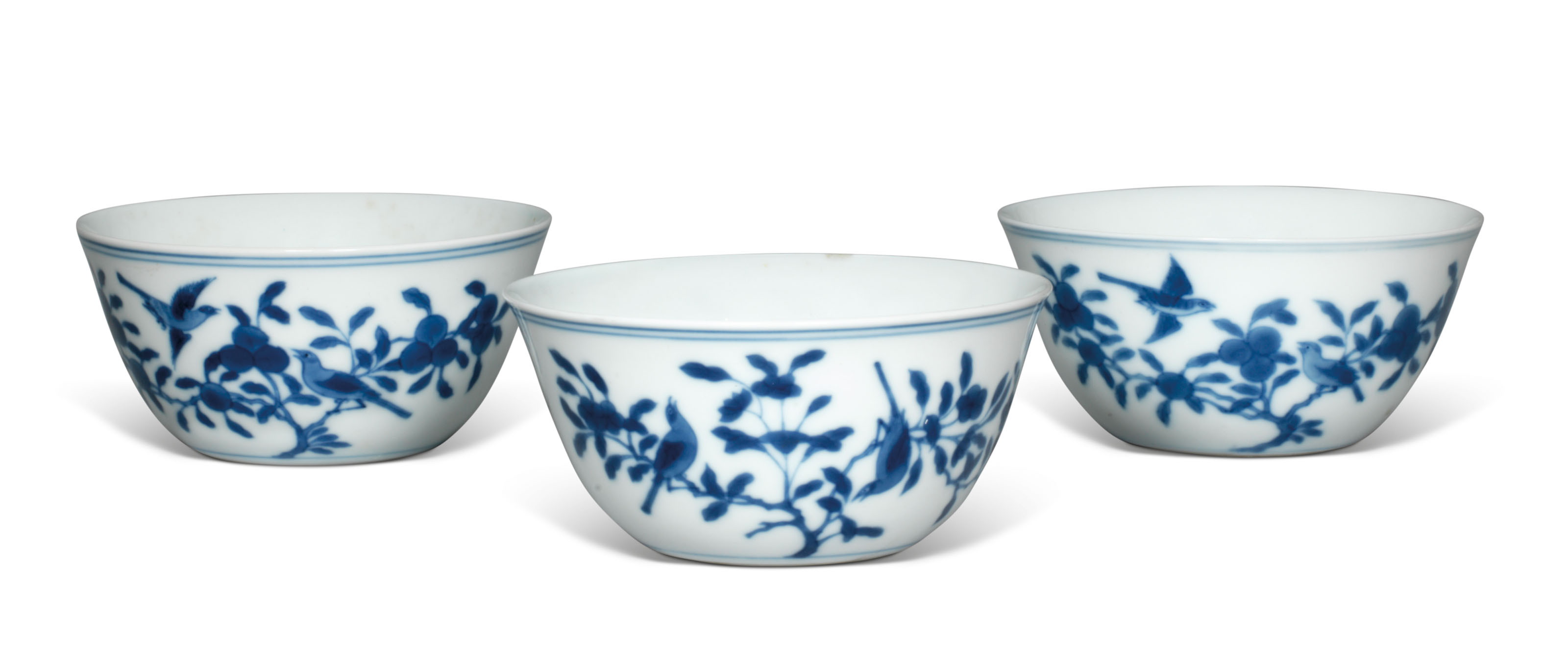 THREE BLUE AND WHITE PORCELAIN ‘BIRD AND FLOWER’ CUPS THREE BLUE AND WHITE PORCELAIN ‘BIRD AND FLOWER’ CUPS