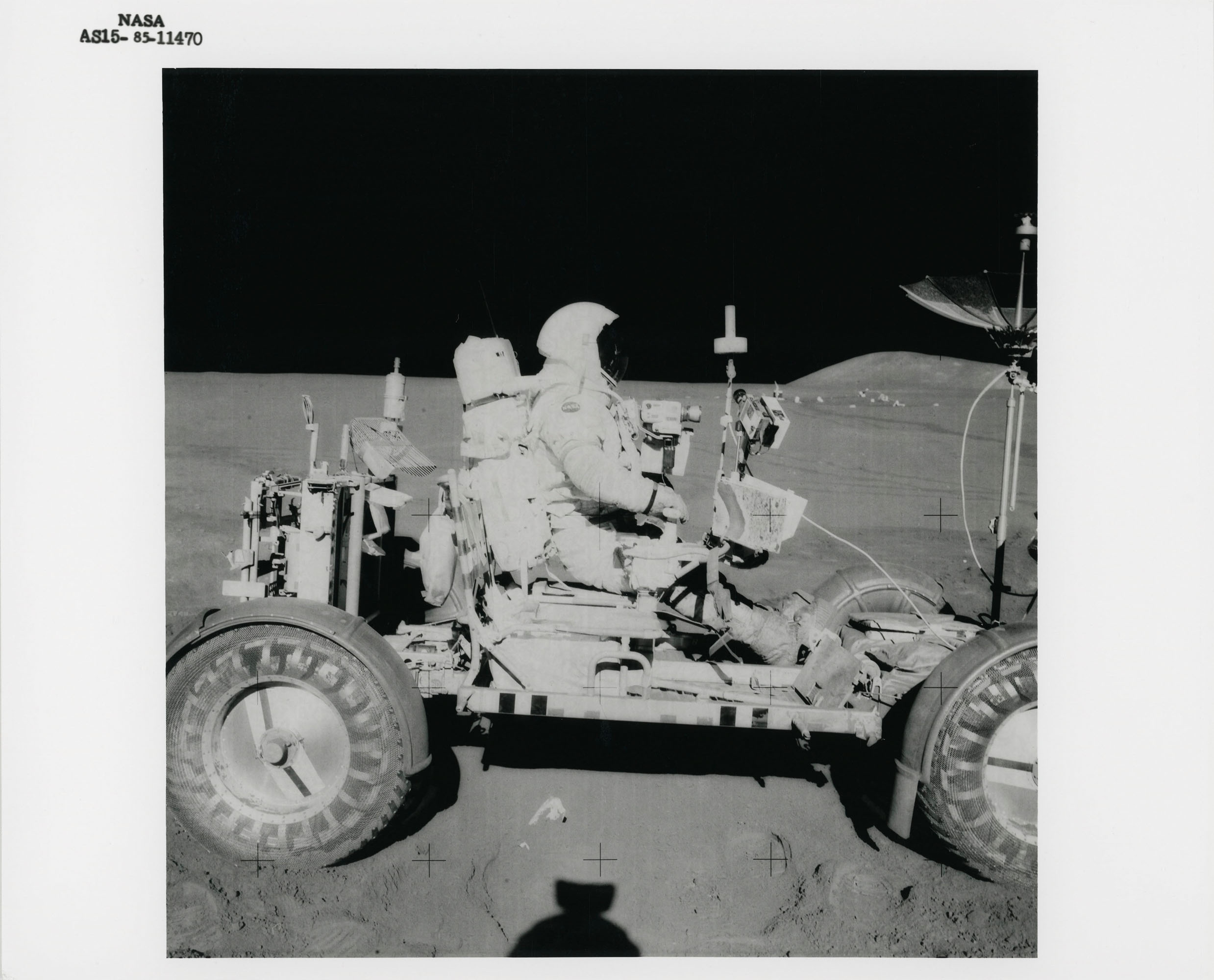 David Scott at his Commander seat of the Lunar Rover; Scott driving the...