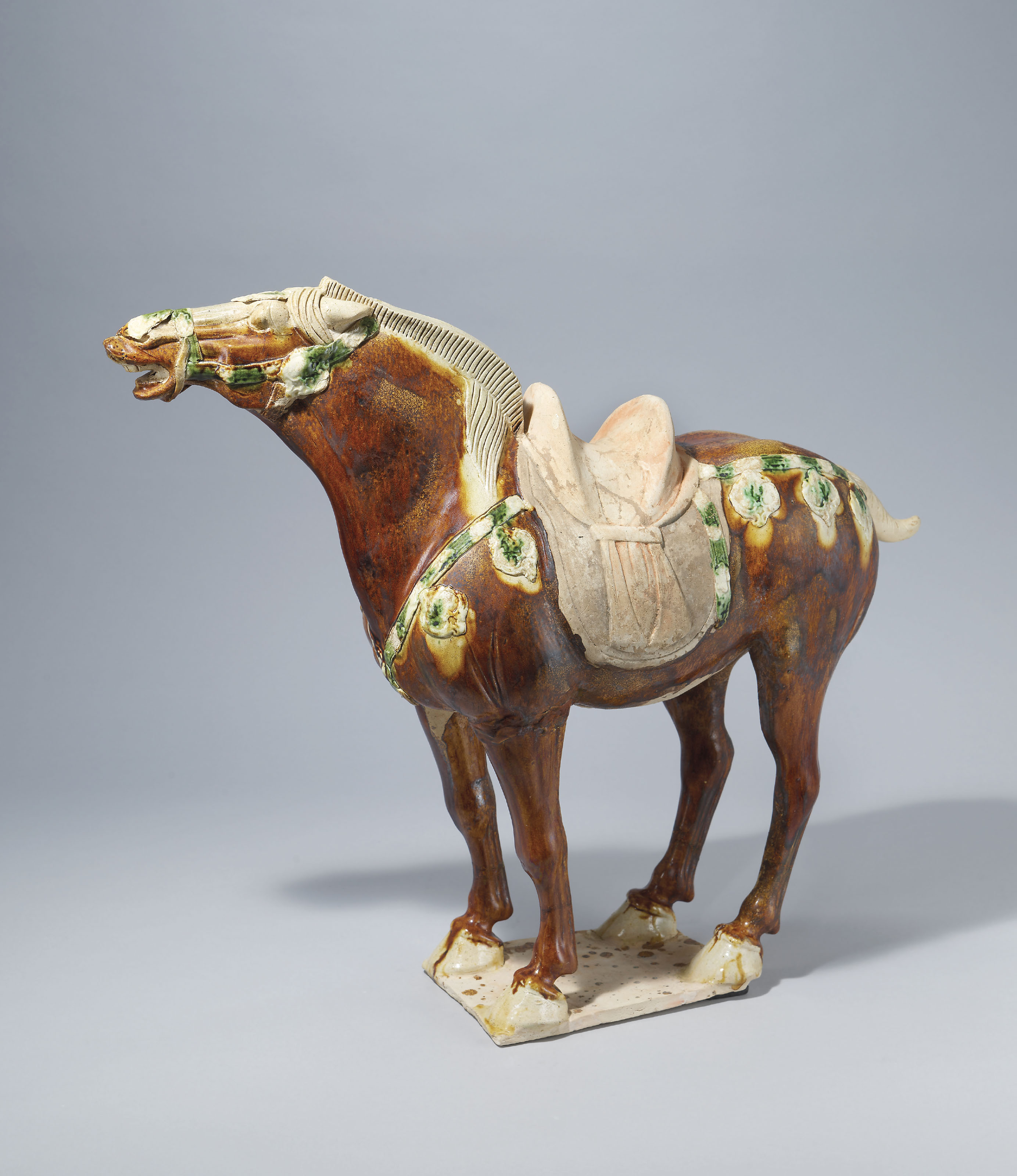 A RARE SANCAIGLAZED POTTERY ‘NEIGHING’ HORSE , TANG DYNASTY (618907
