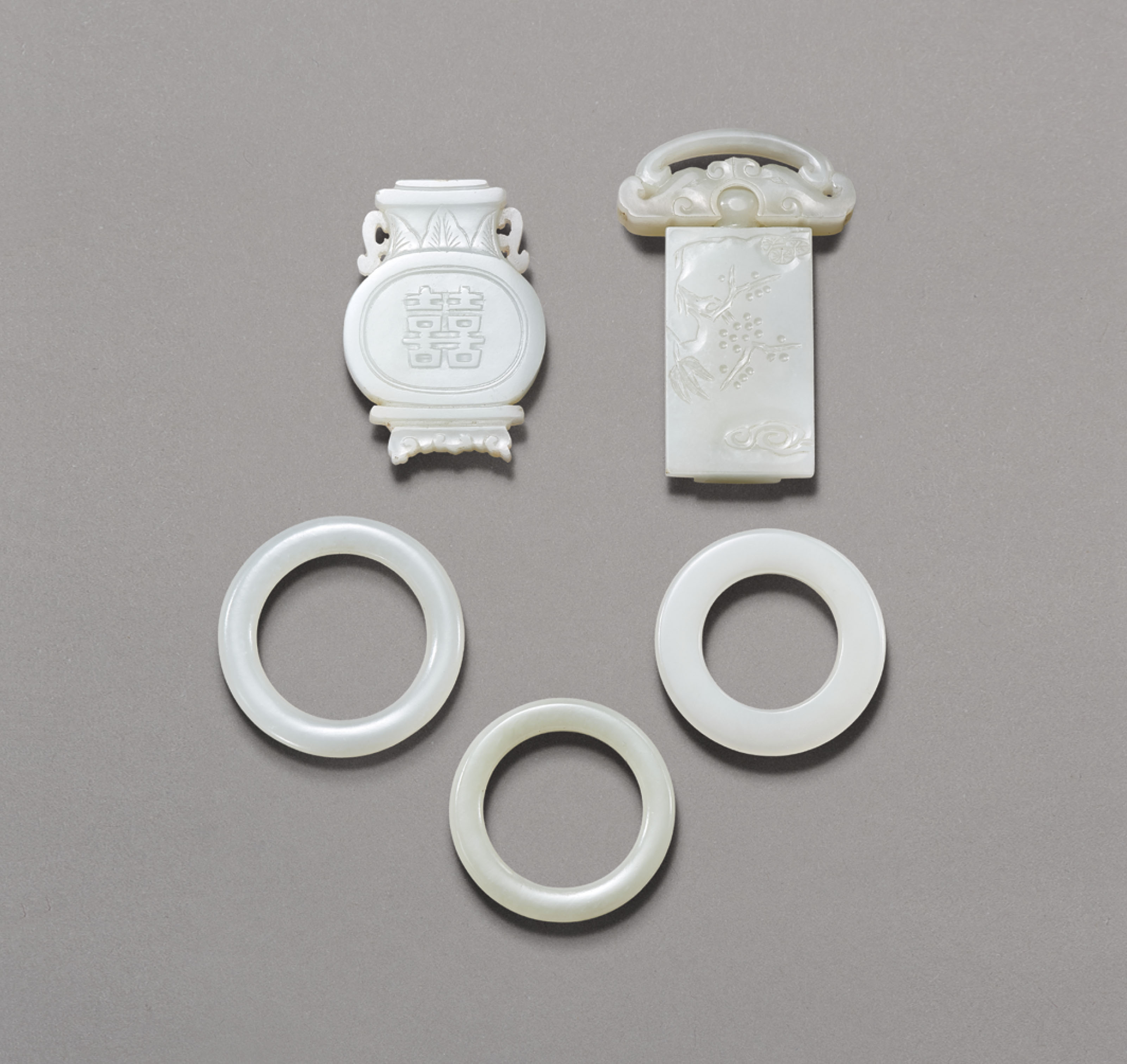 TWO WHITE JADE BELT BUCKLES AND THREE SMALL WHITE JADE RINGS